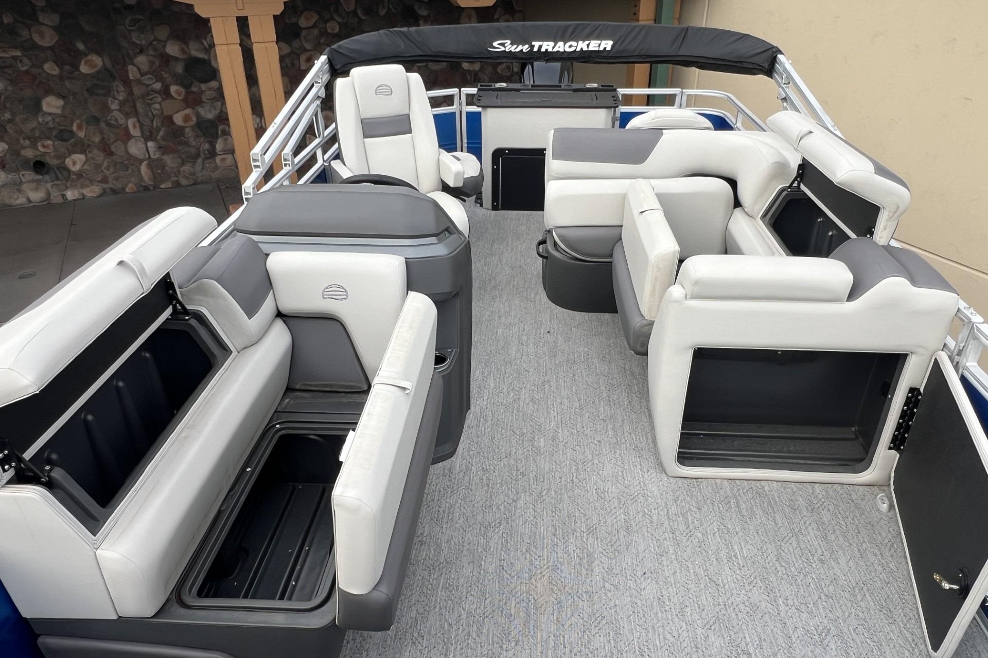 2026 Sun Tracker Fishin' Barge 20 DLX interior with spacious seating and storage compartments.