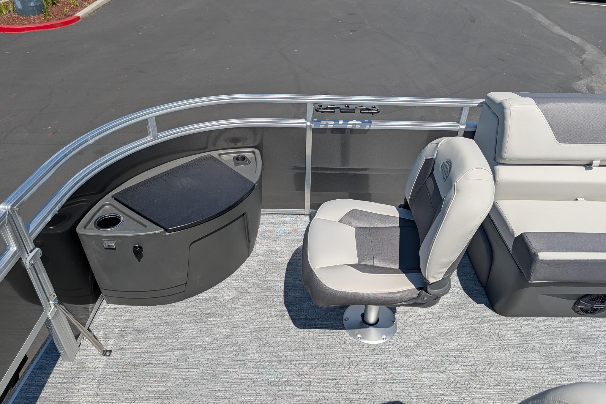 2026 Sun Tracker Fishin' Barge 22 DLX interior with seating and storage.