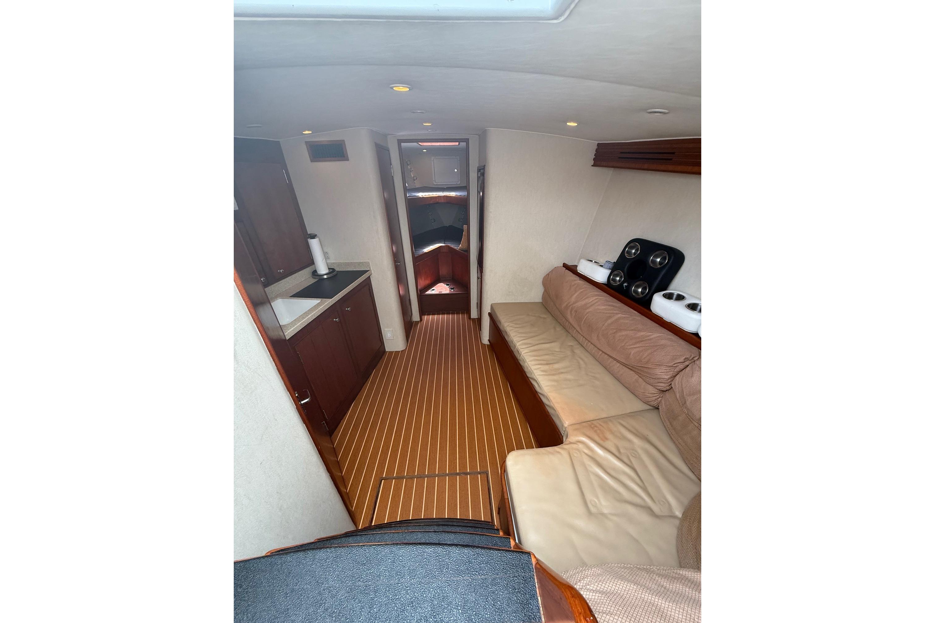 Interior of 2006 Custom Carolina Heritage Express boat with cozy seating and kitchenette.