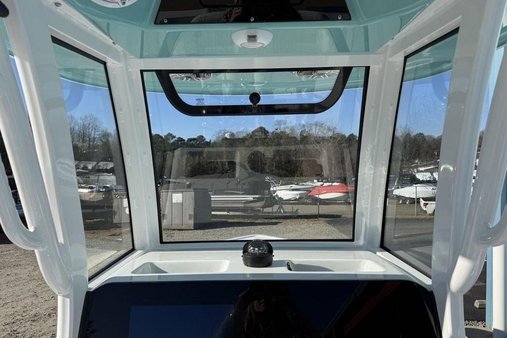 Interior view of 2026 Sportsman Masters 247OE Bay Boat cockpit with clear windows.