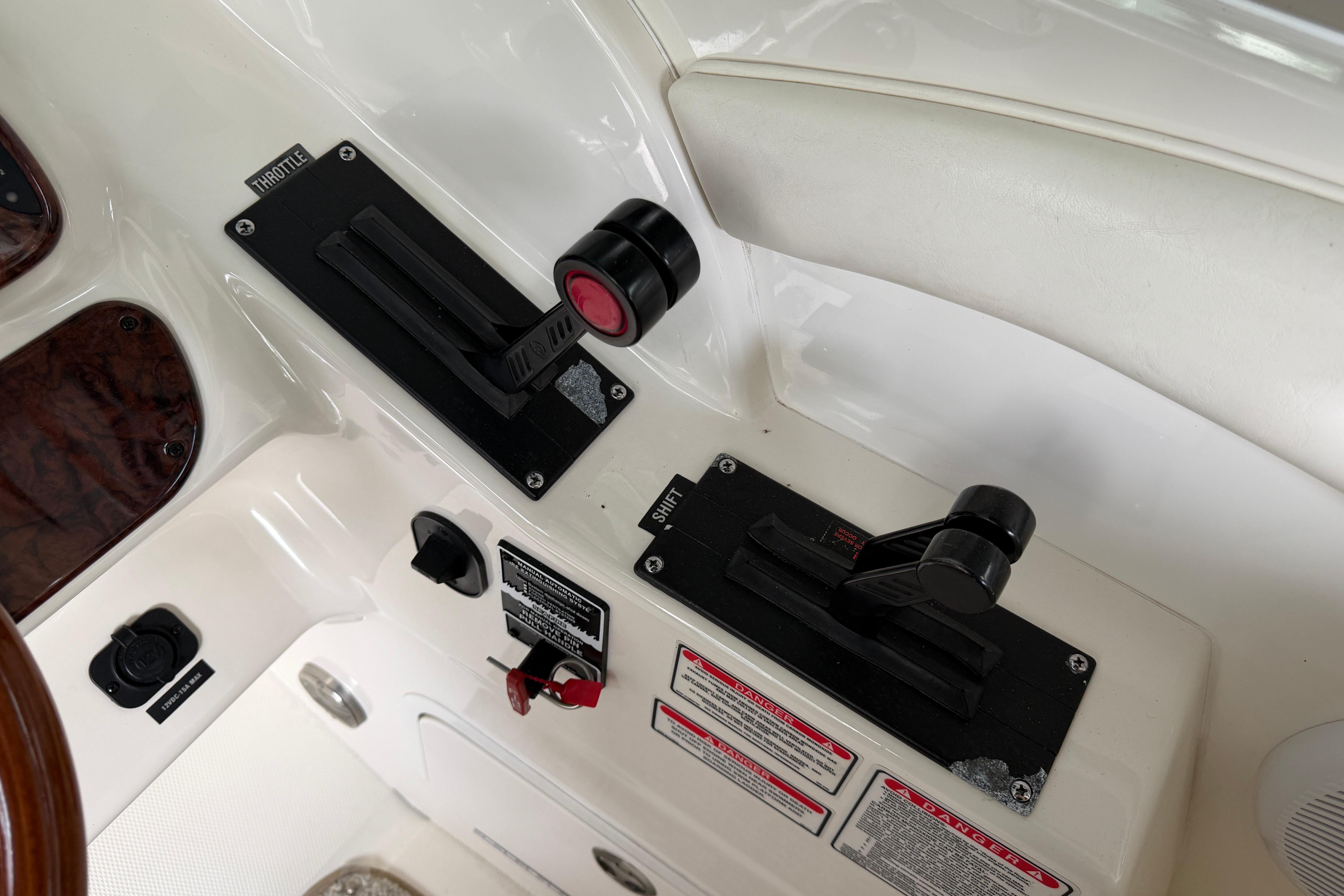 Throttle controls on a 2003 Sea Ray 290 Bowrider boat dashboard.