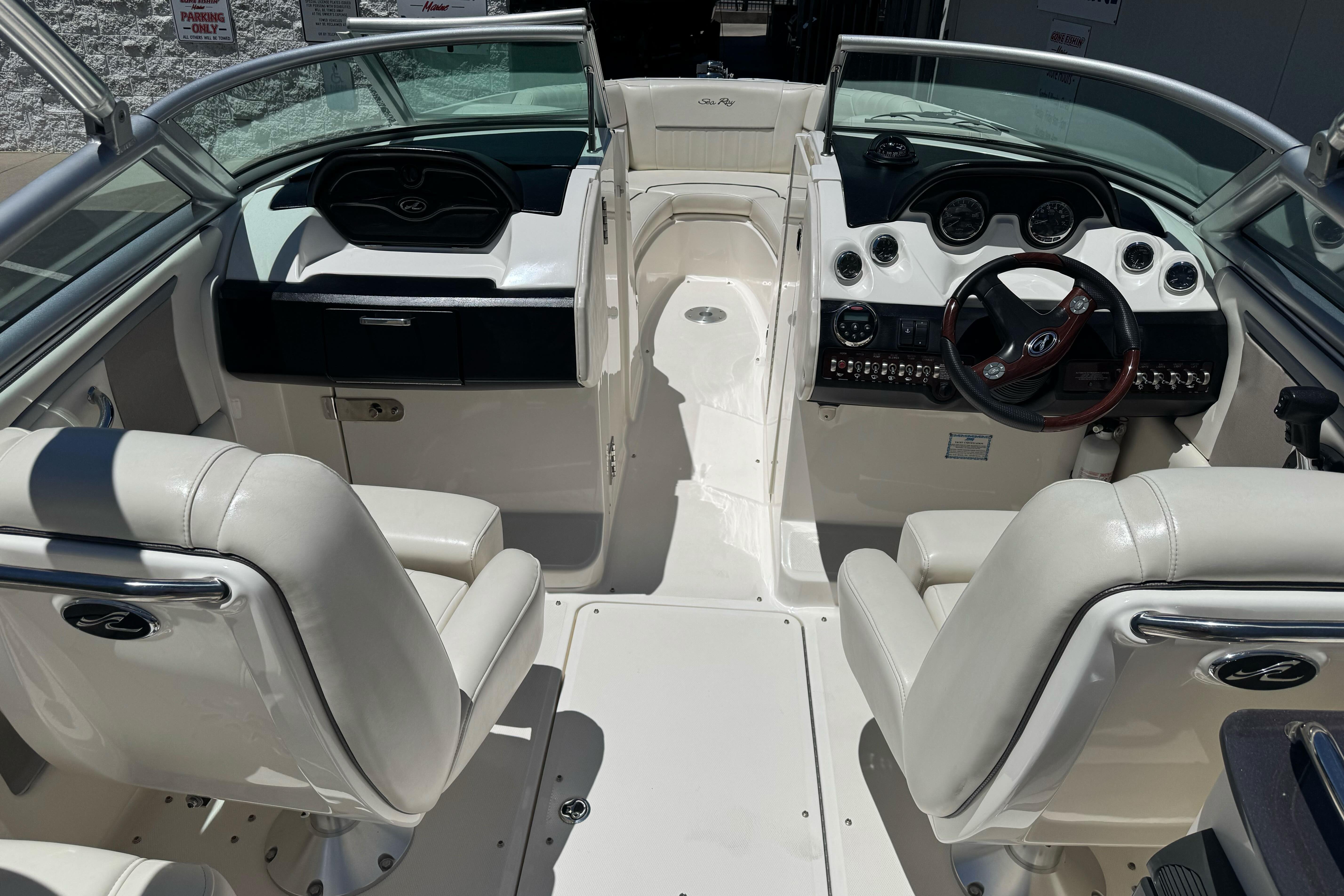 Interior view of a 2007 Sea Ray SLX 250 boat with white seating and dashboard.