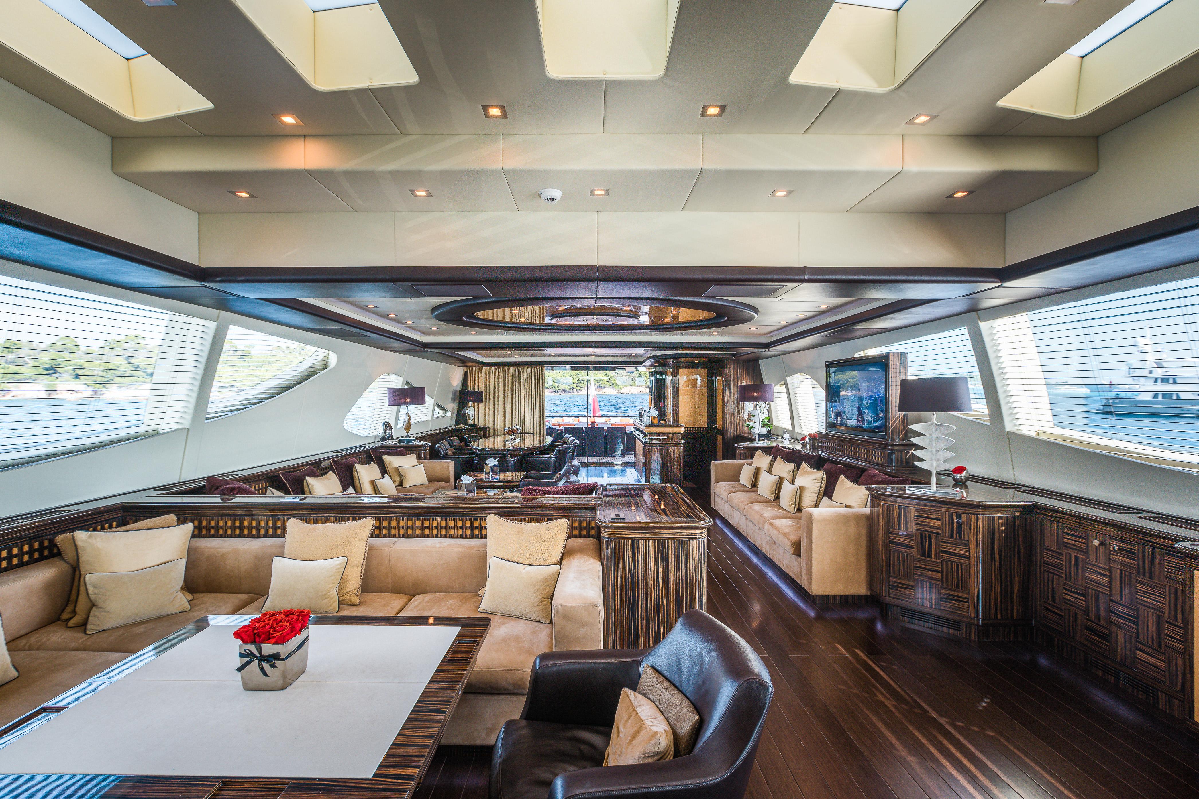 Luxurious interior of 2011 Mangusta 165 yacht with elegant seating and modern design.