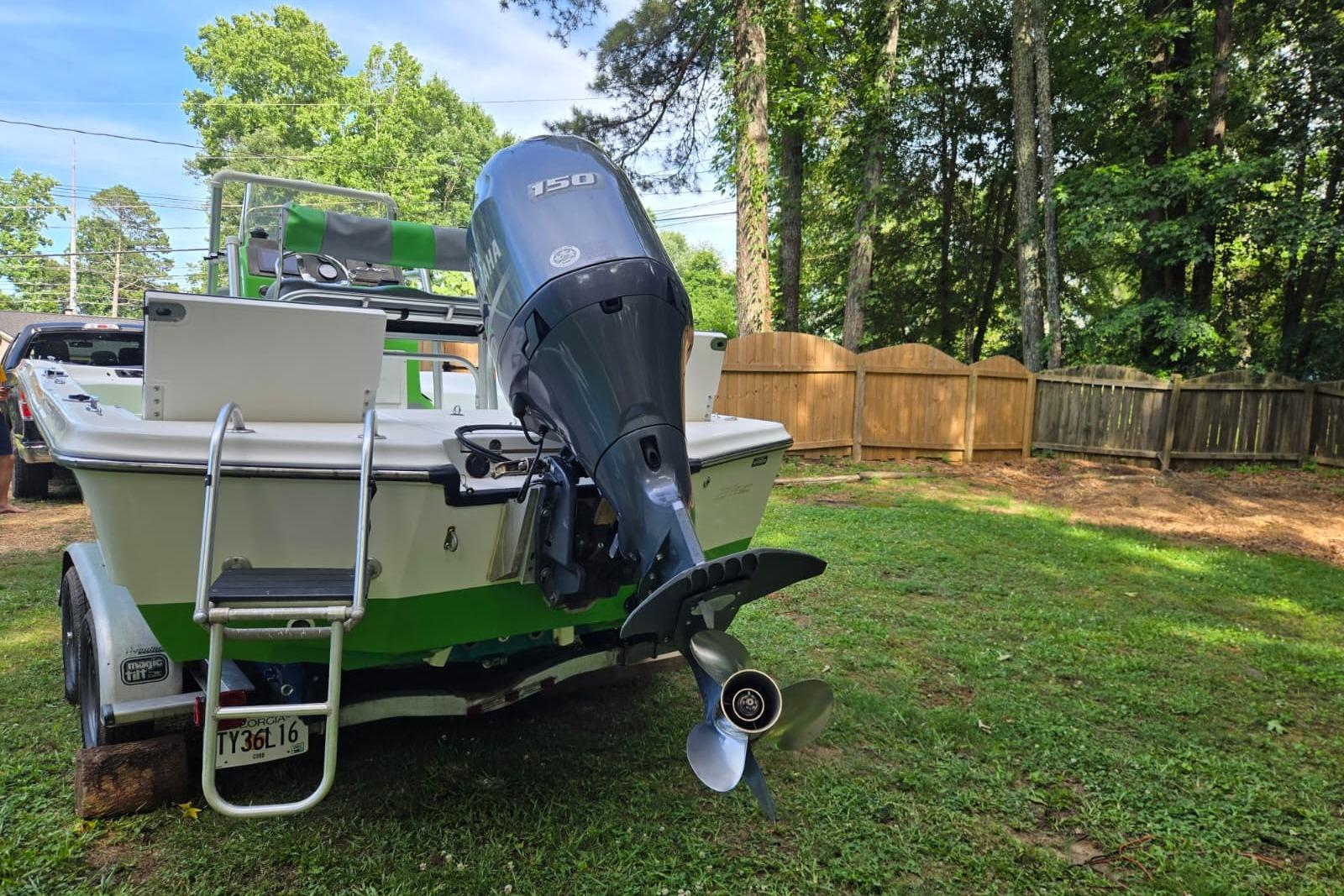 2016 Epic 21 Sport Console boat with Yamaha 150 engine in a grassy yard.