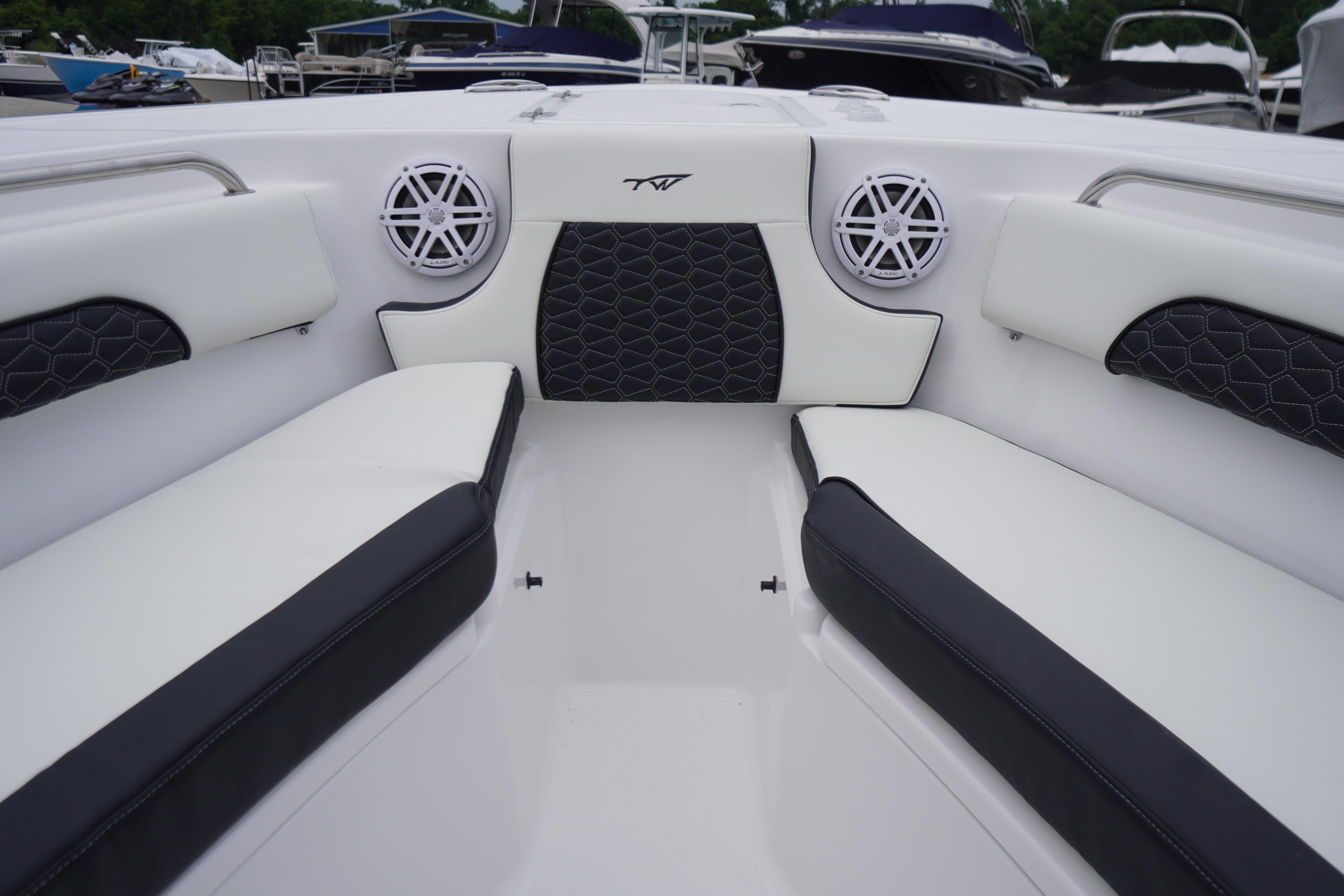 Interior of 2026 Tidewater 232 SS boat with stylish seating and speakers.