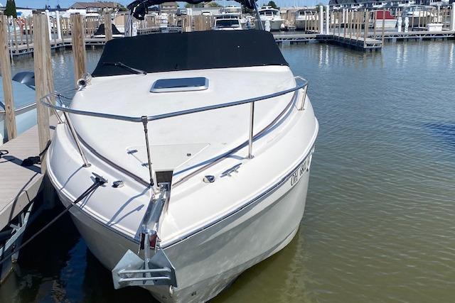 2005 Rinker Fiesta Vee 250 boat docked at a marina, front view.