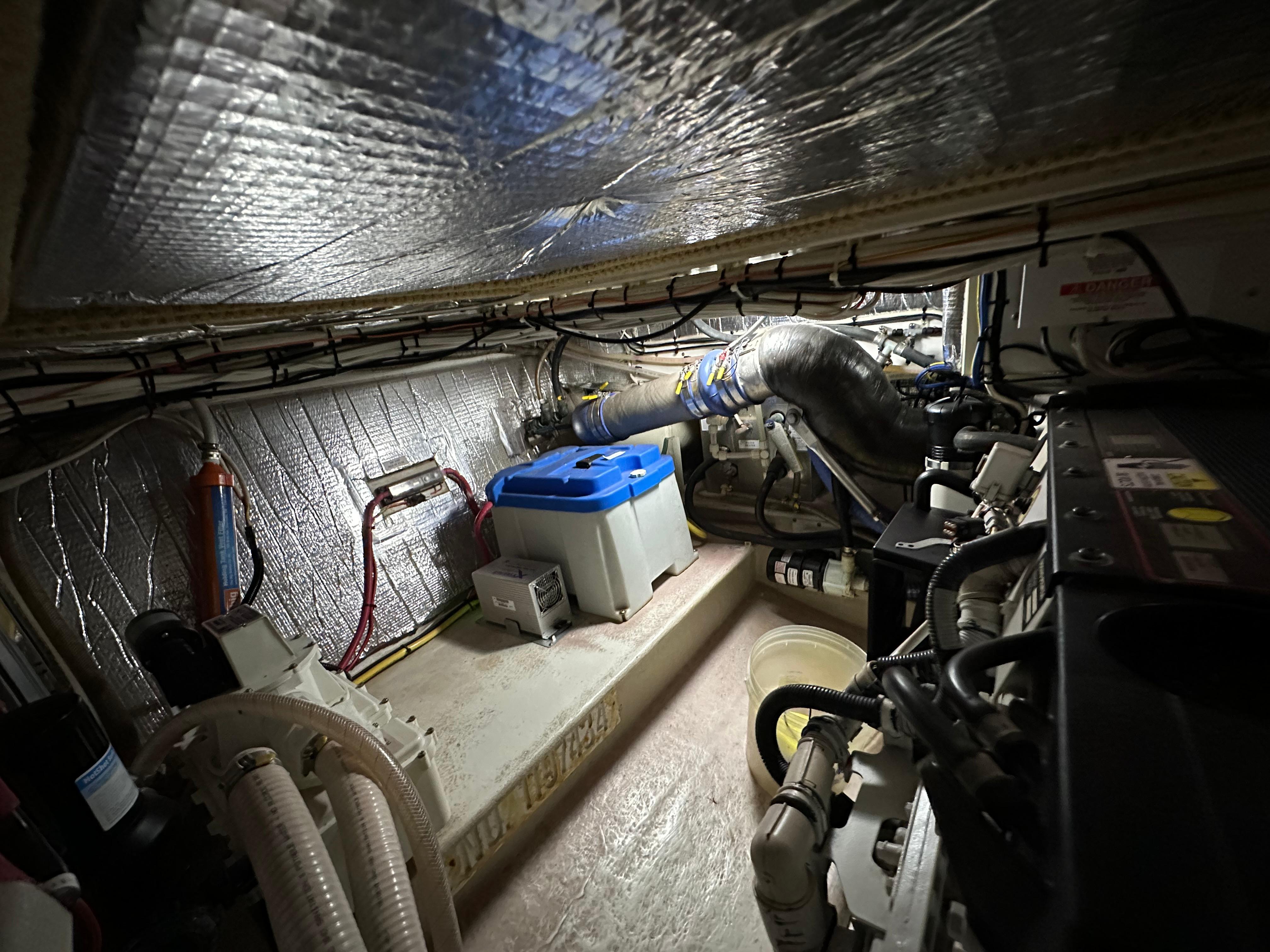 Engine room of a 2007 Nordic Tug 32, featuring insulated walls and mechanical components.