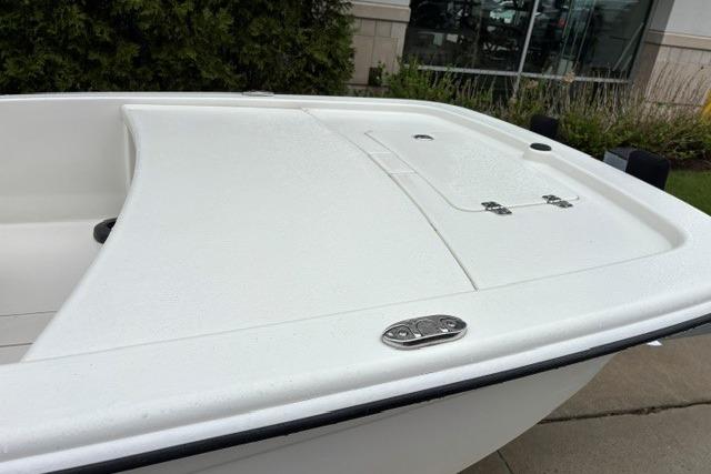 2025 Mako Pro Skiff 13 CC boat, white deck, sleek design, outdoor display.