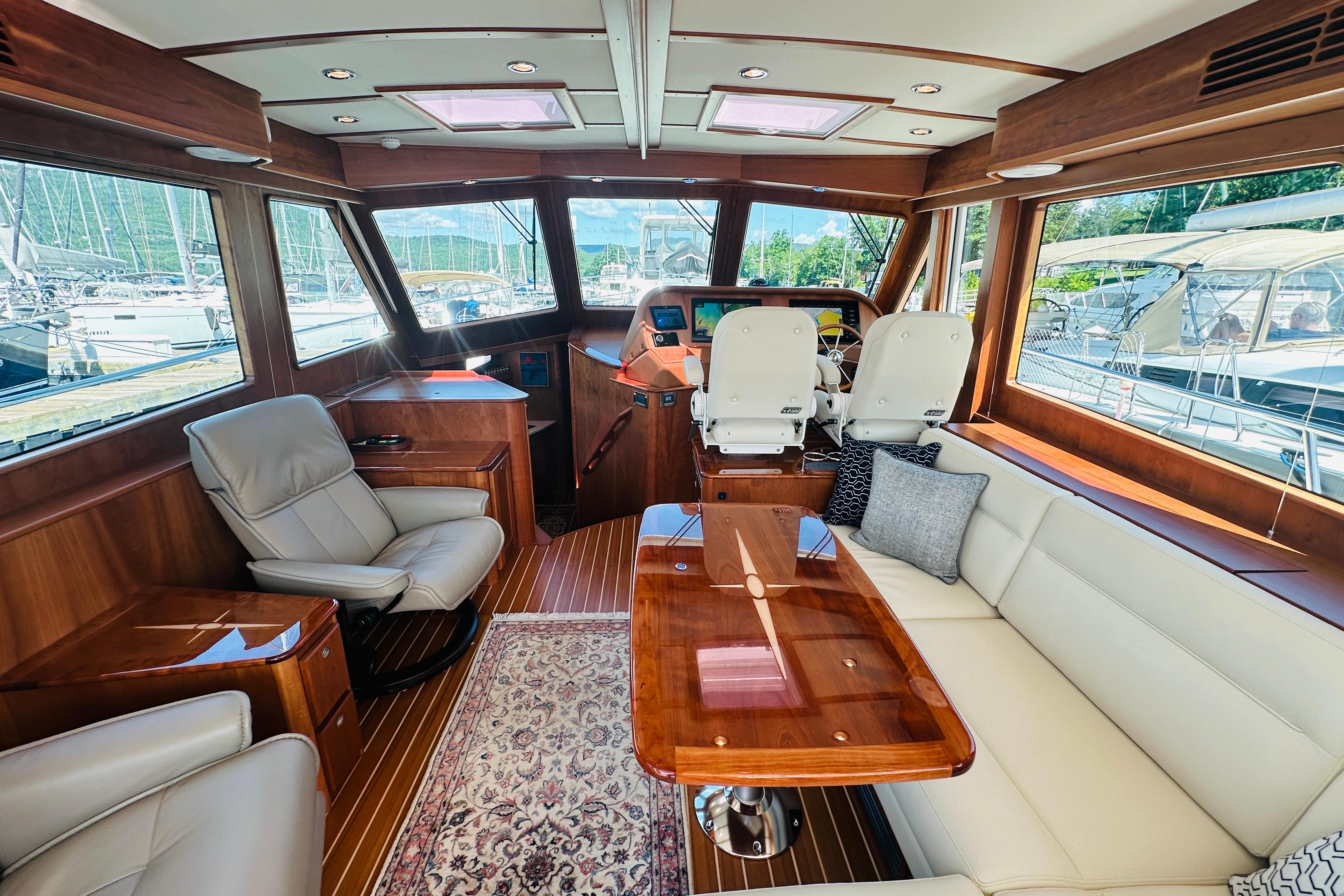 Luxurious interior of 2025 Sabre 48 Salon Express yacht with elegant seating and wood finishes.