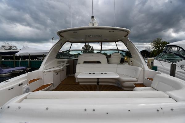 2003 Sea Ray 460 Sundancer yacht with spacious seating under cloudy skies.