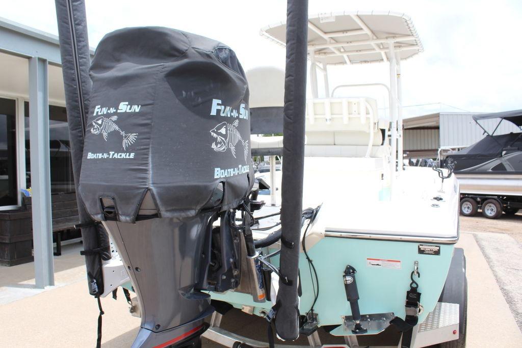 2026 Skeeter SX230 boat with covered outboard motor, parked on a trailer.