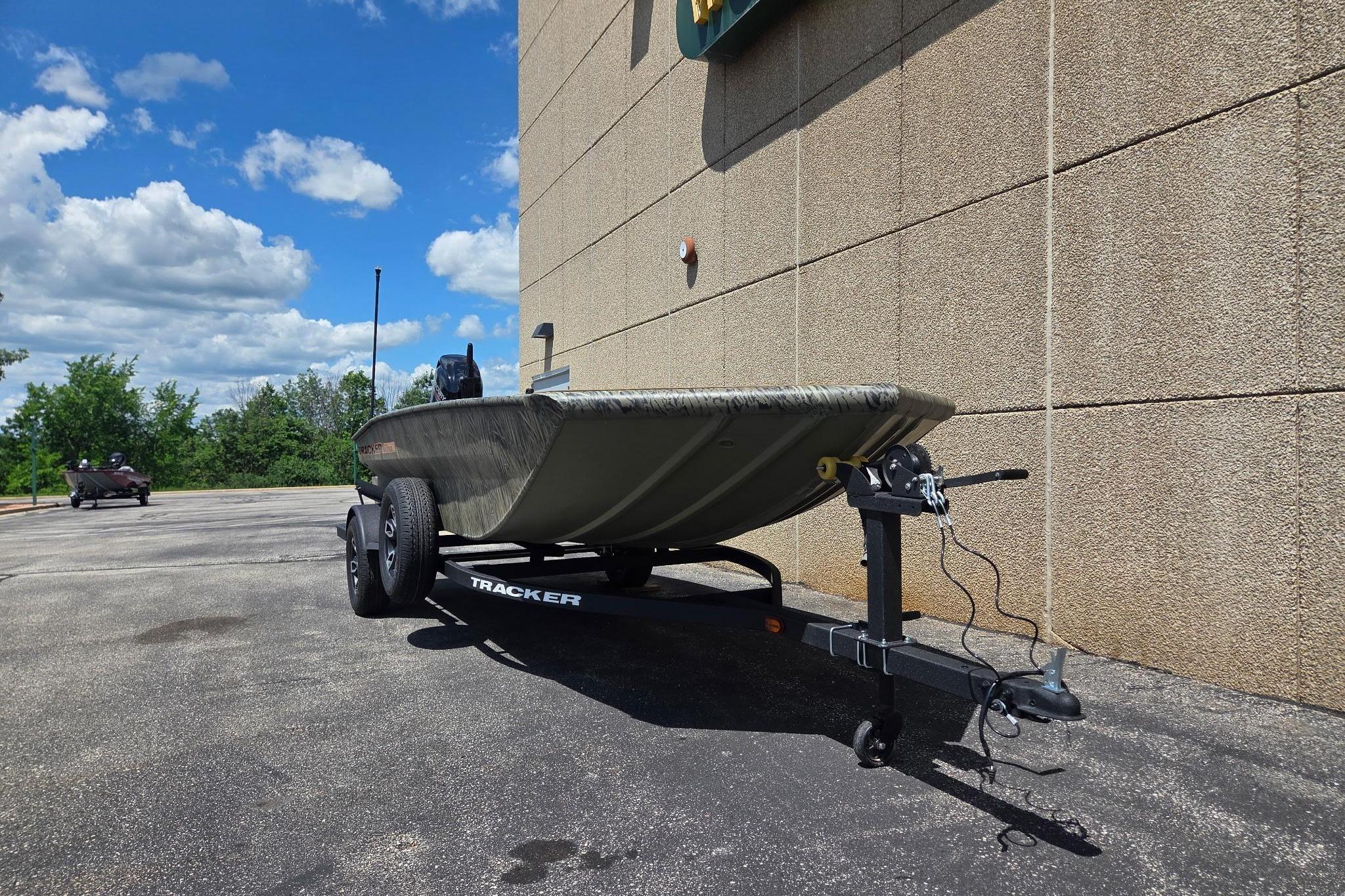 2026 Tracker Grizzly 1756 T Marsh boat on trailer, parked outdoors under blue sky.