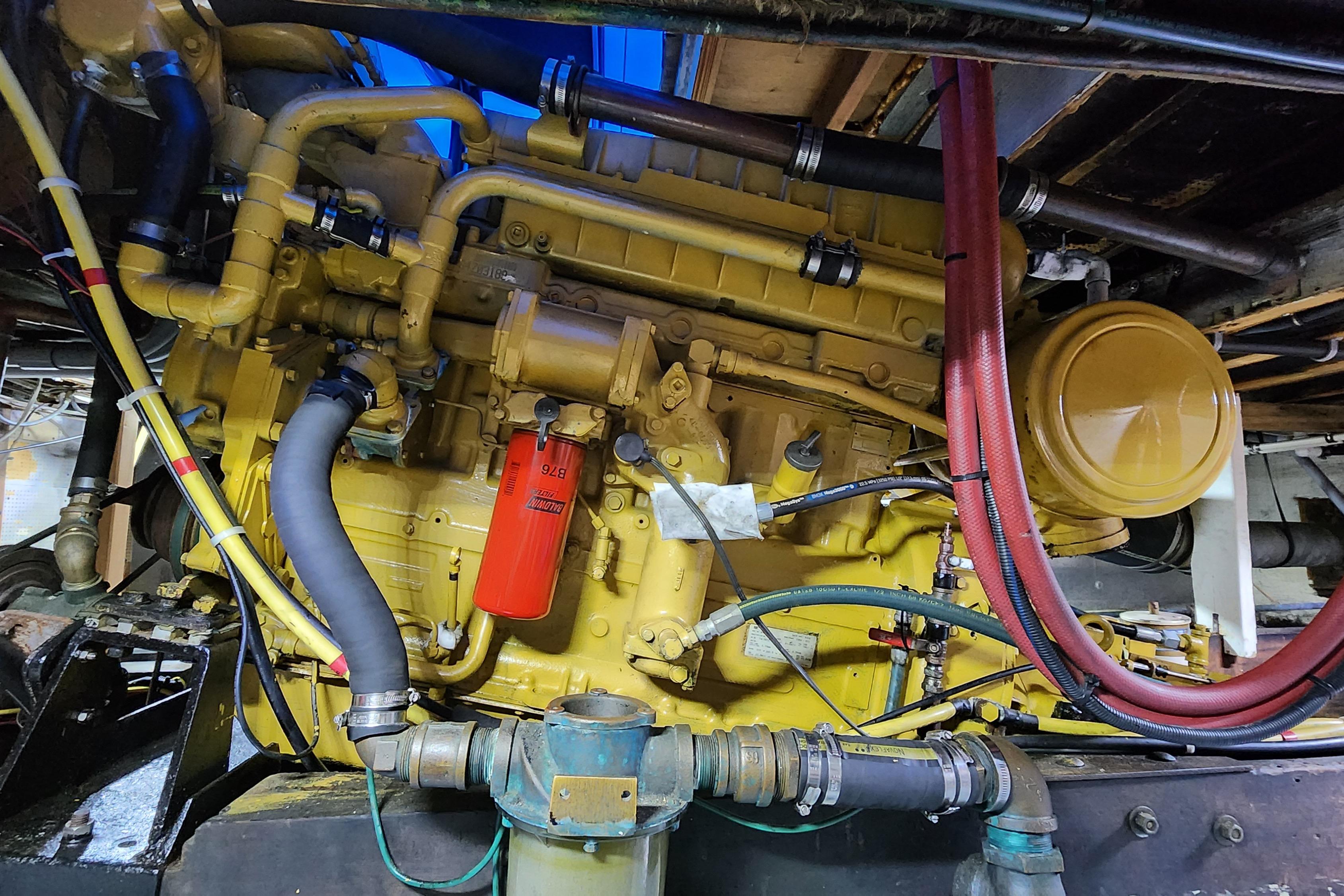 Engine of a 1964 Grandy Tour Boat with visible hoses and components.