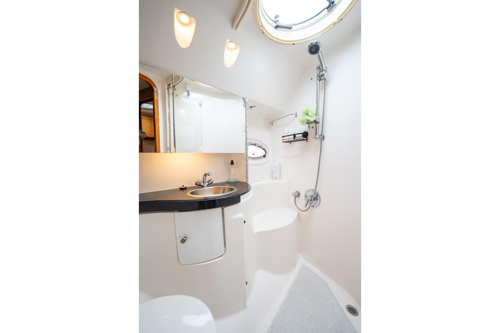 Luxurious bathroom in 2008 Regal Commodore 4460 yacht with modern fixtures and lighting.