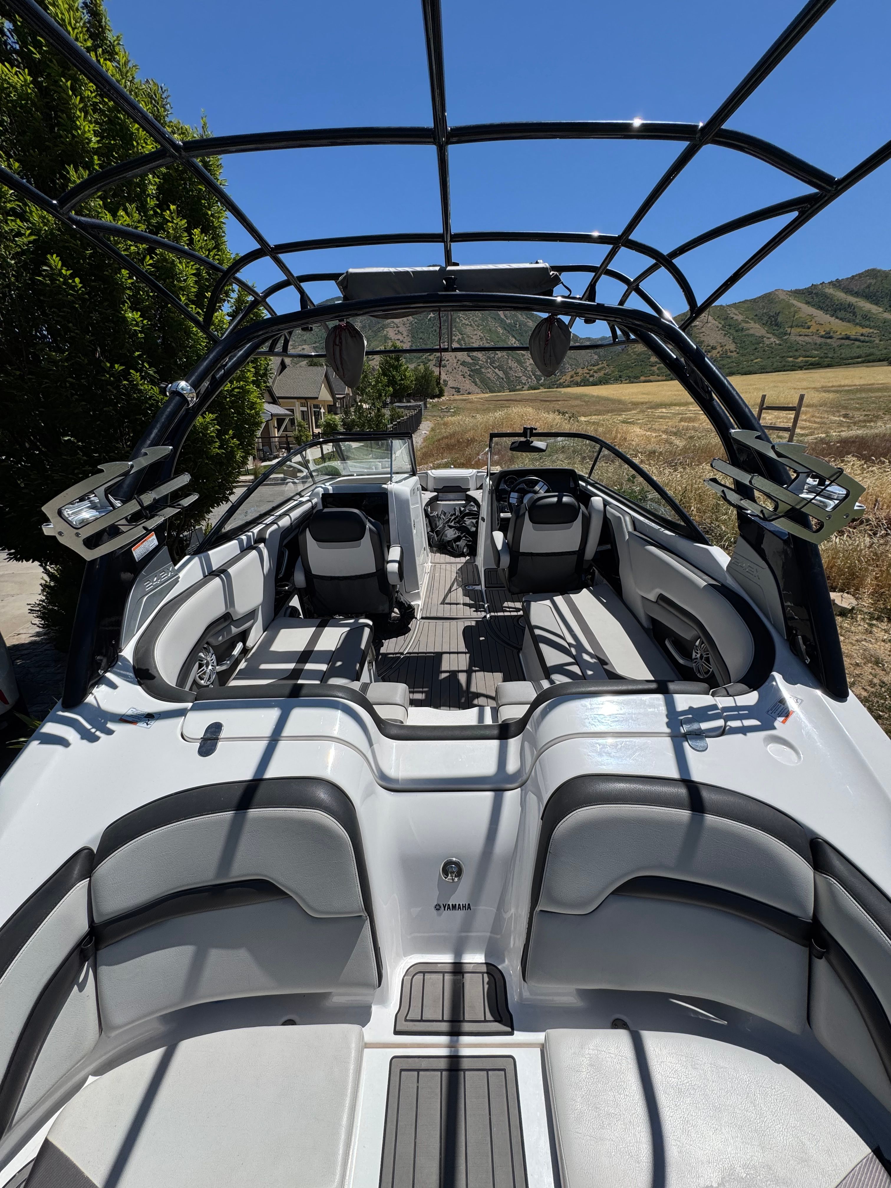 The image shows a 2017 Yamaha 242X E-Series boat with an open deck and seating.
