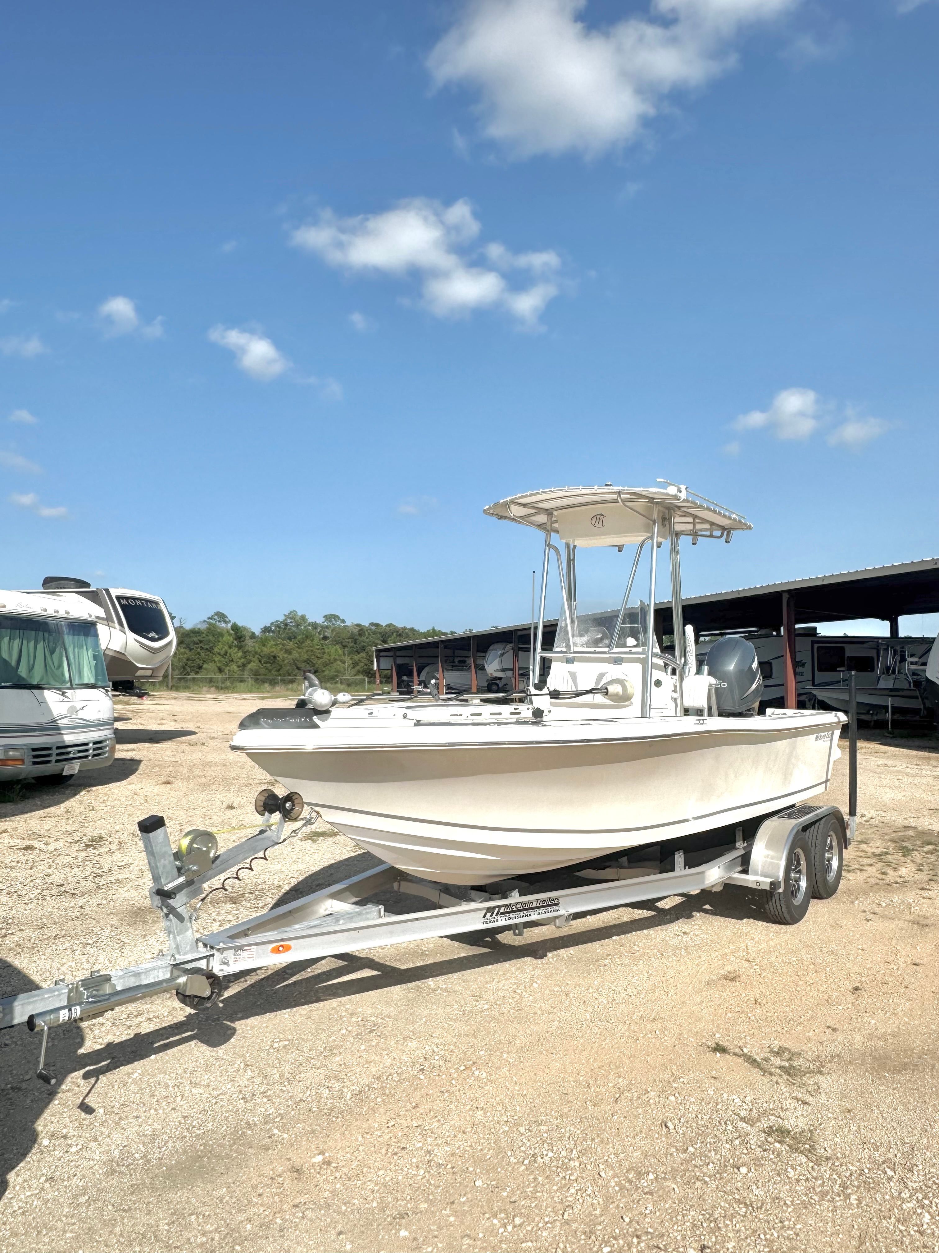 A 2007 McKee Craft Marathon 196 CC boat on a trailer in a gravel lot.