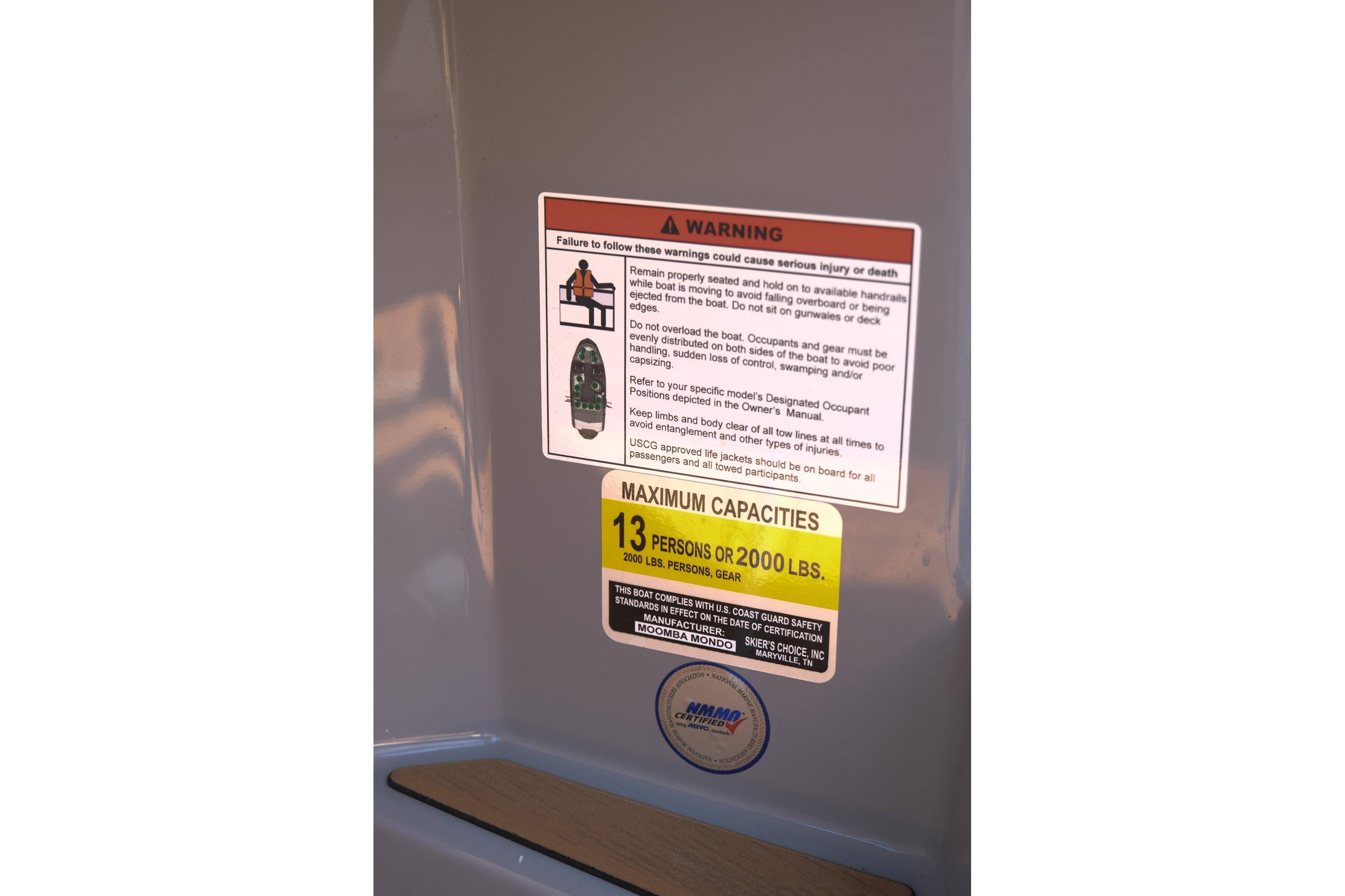 2023 Moomba Mondo boat warning label showing maximum capacity of 13 persons or 2000 lbs.