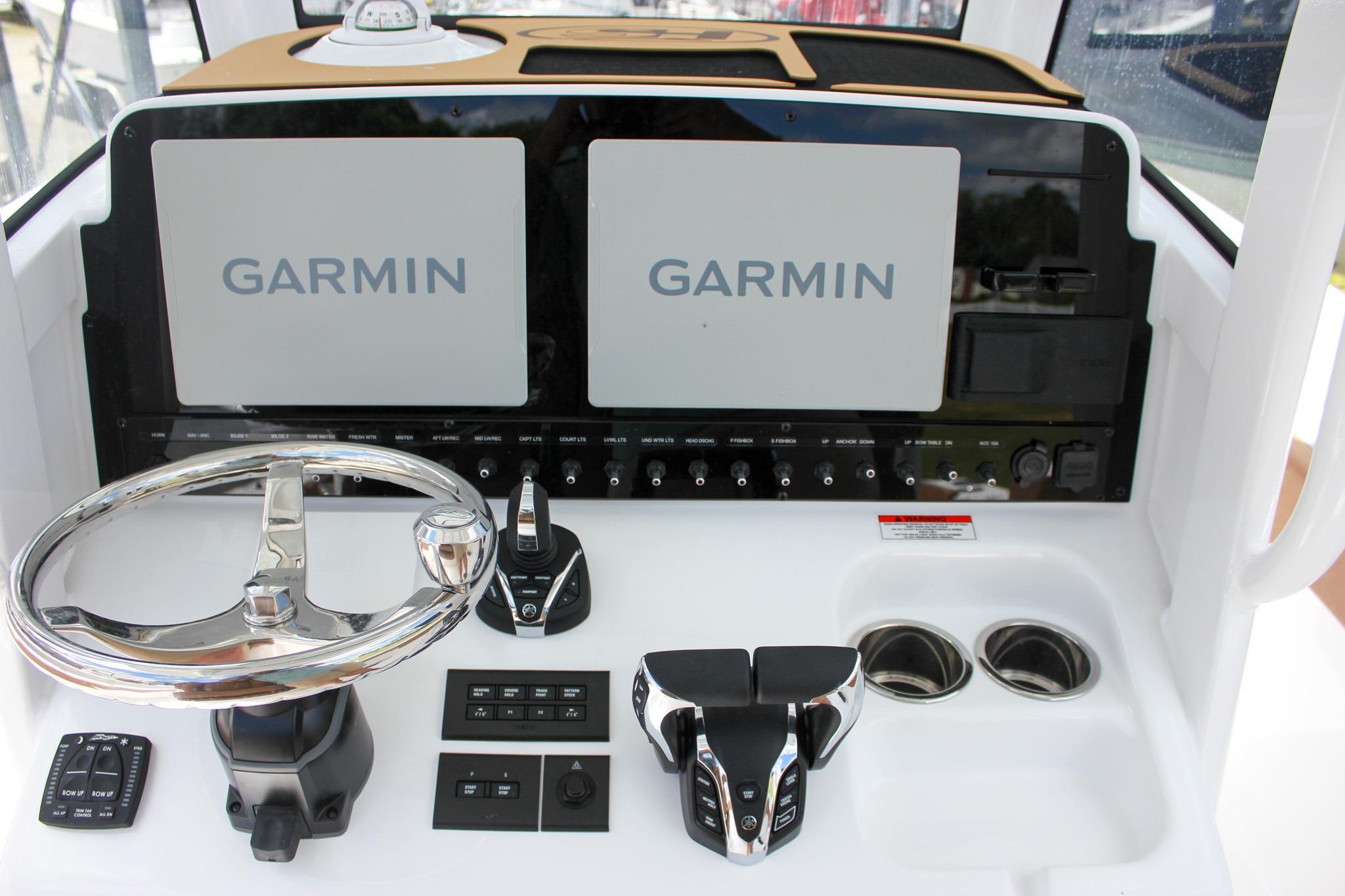 Dashboard of 2027 Sea Hunt Ultra 275 SE with Garmin displays and controls.