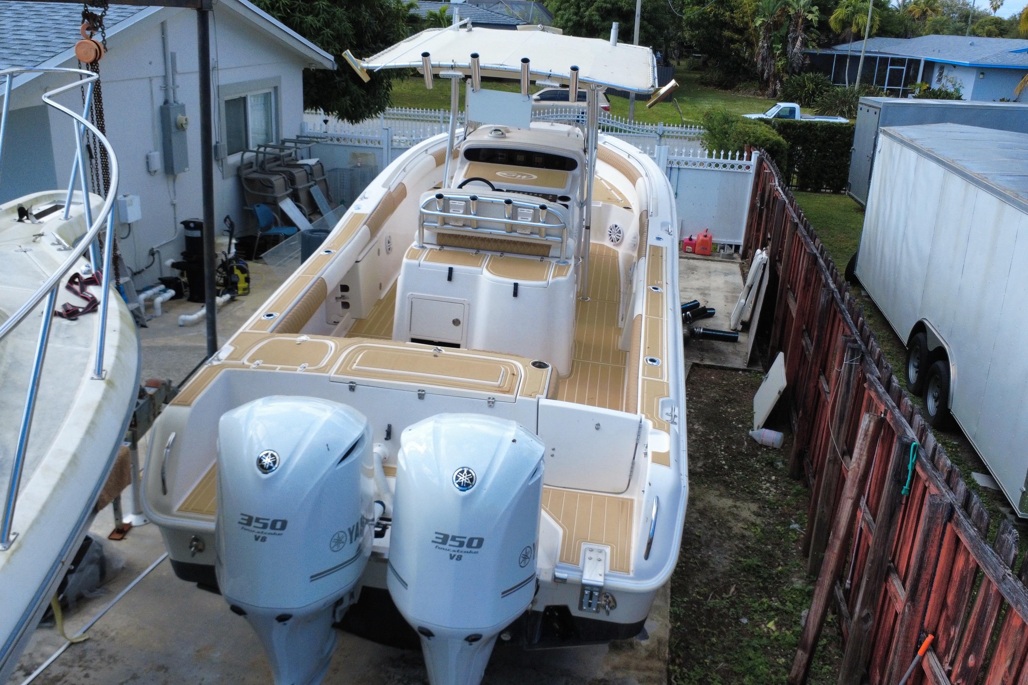 2004 Grady-White Canyon 283 boat with dual Yamaha 350 V8 engines in a driveway.