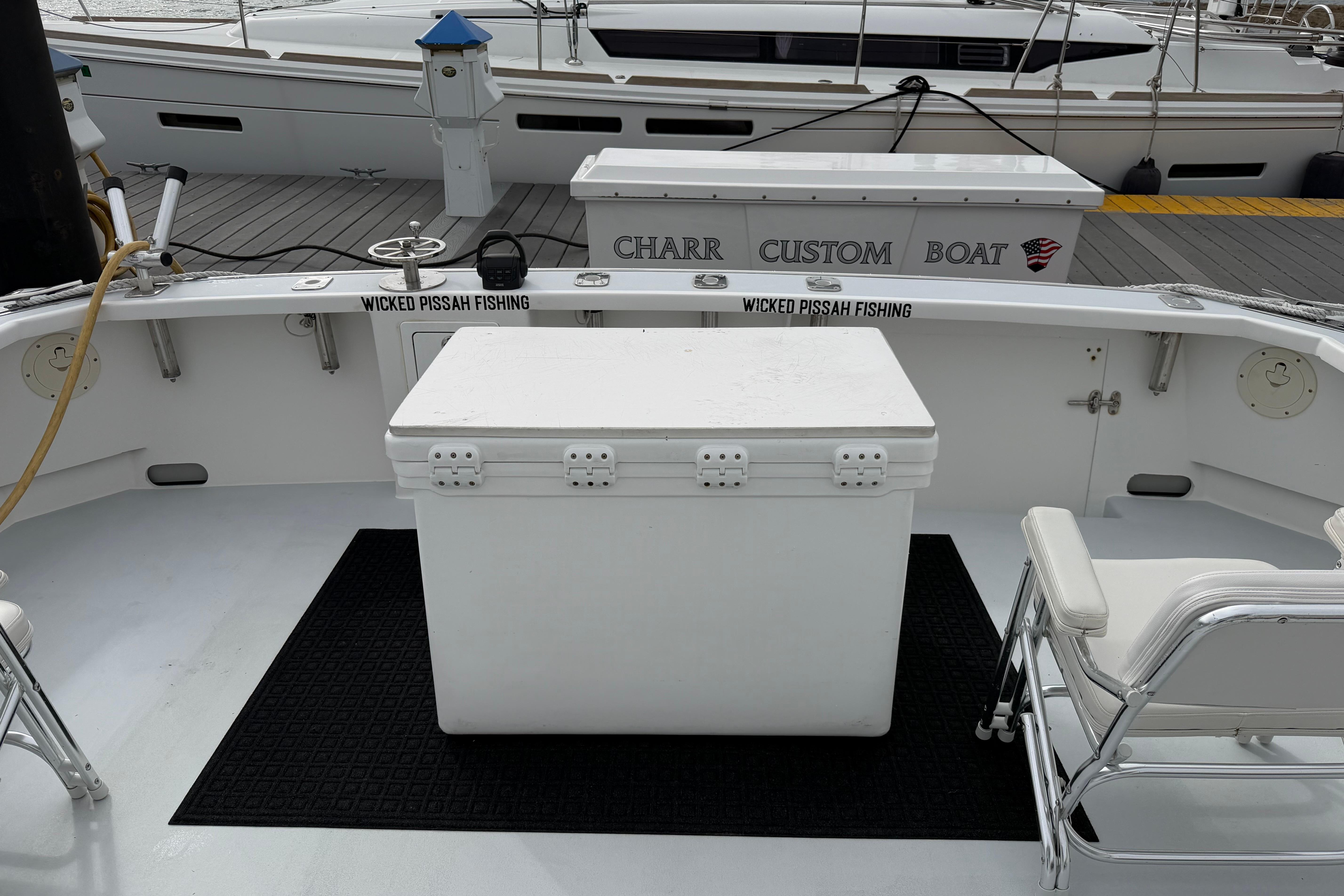 Fishing boat deck with cooler and chairs, H&H Marine Osmond Beal 2018 model.