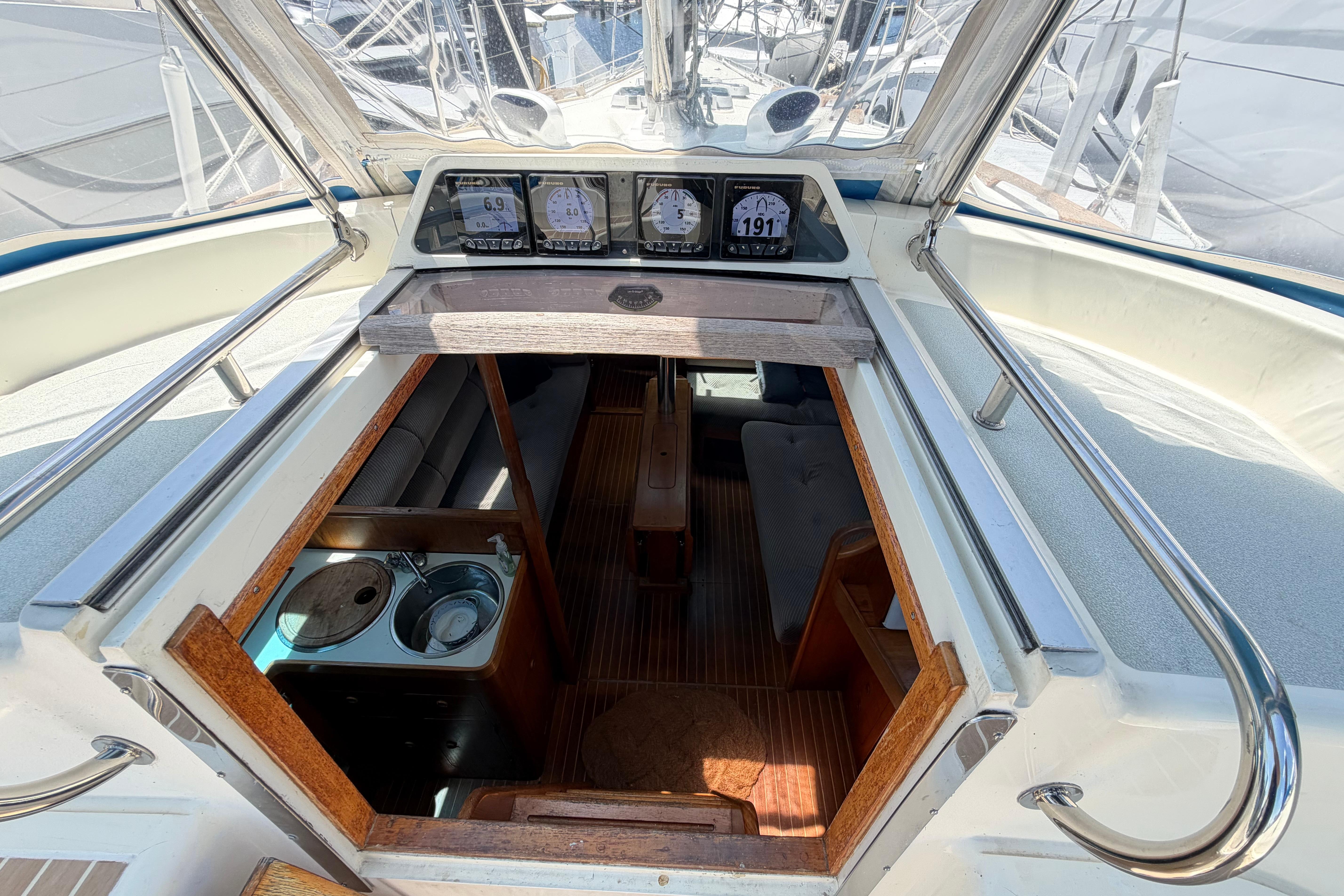 Interior view of a 1987 Moody 376 sailboat, showcasing the cabin entrance and navigation instruments.