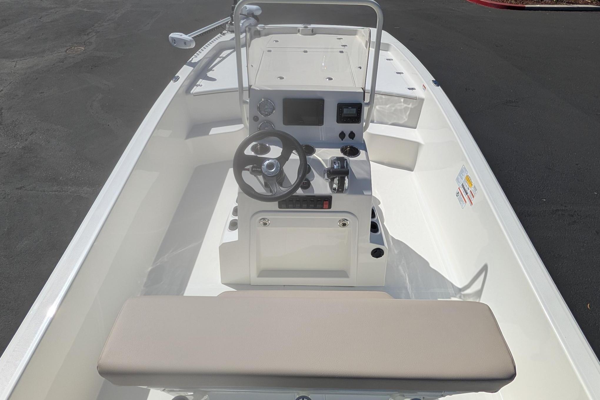 2026 Mako Pro Skiff 19 CC boat interior with steering console and seating.