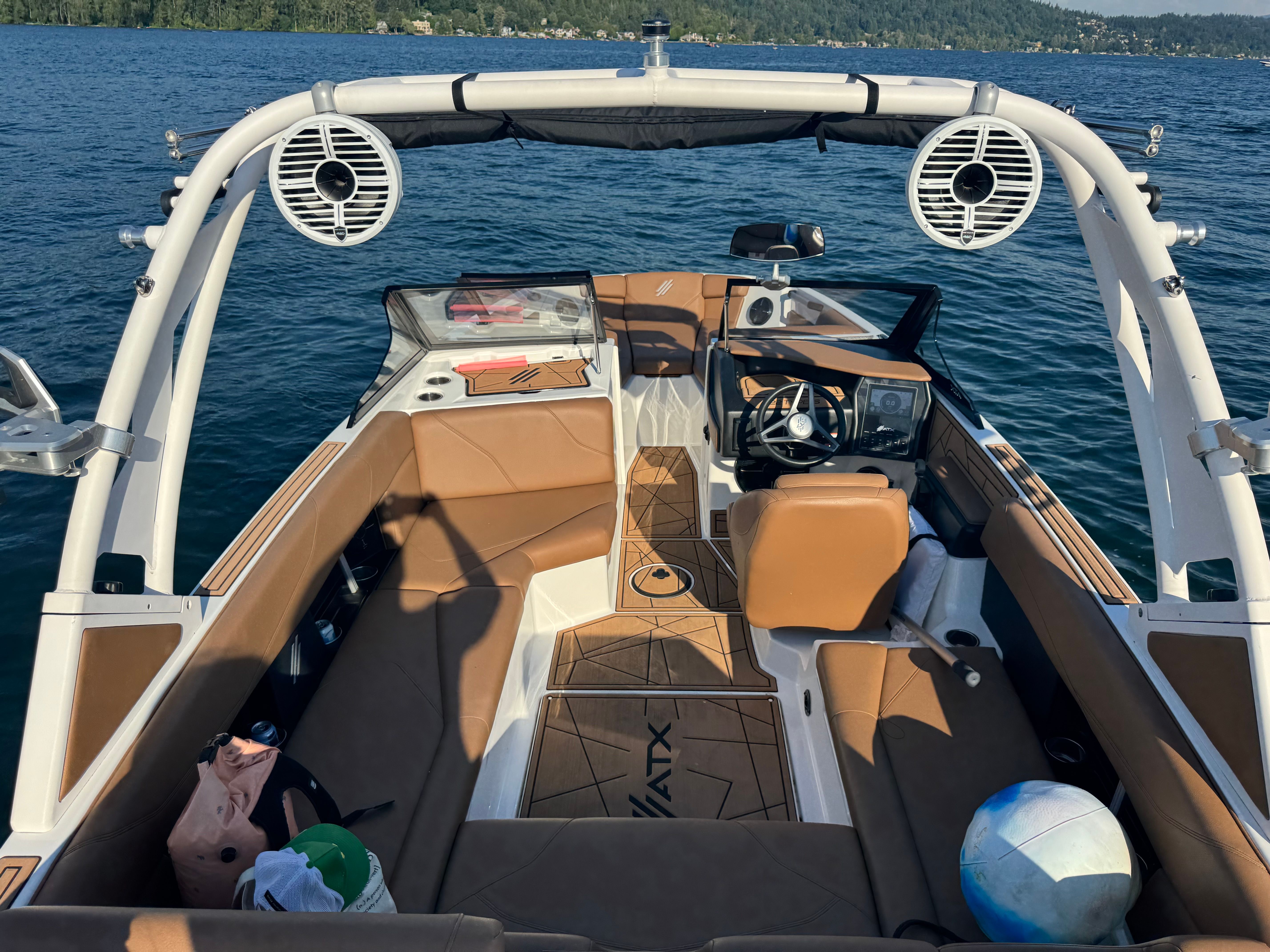 The 2022 ATX Surf Boat 22 Type-S features a modern cockpit with brown seating.