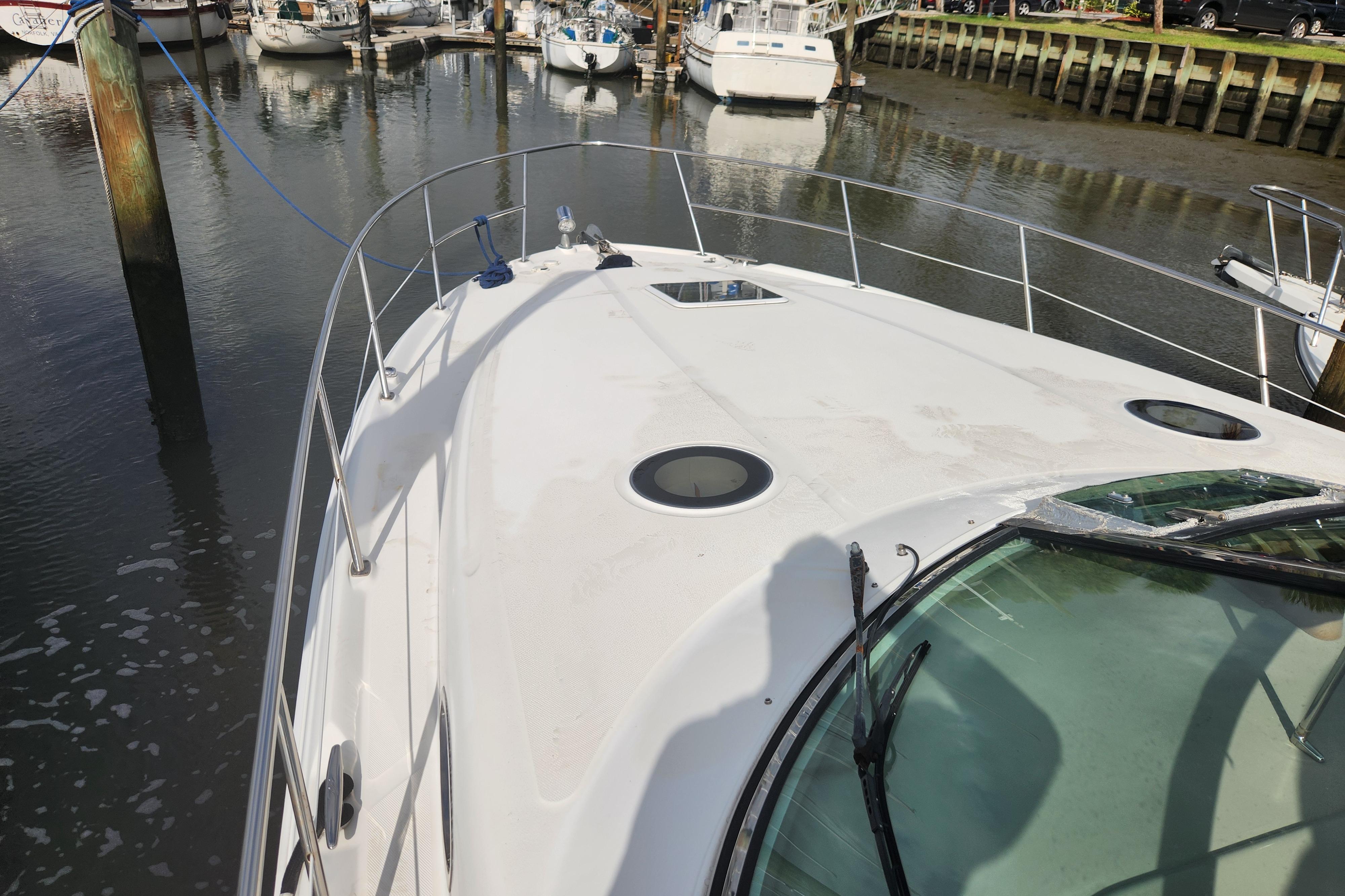2003 Sea Ray 360 Sundancer yacht docked in a marina, showcasing its sleek deck design.