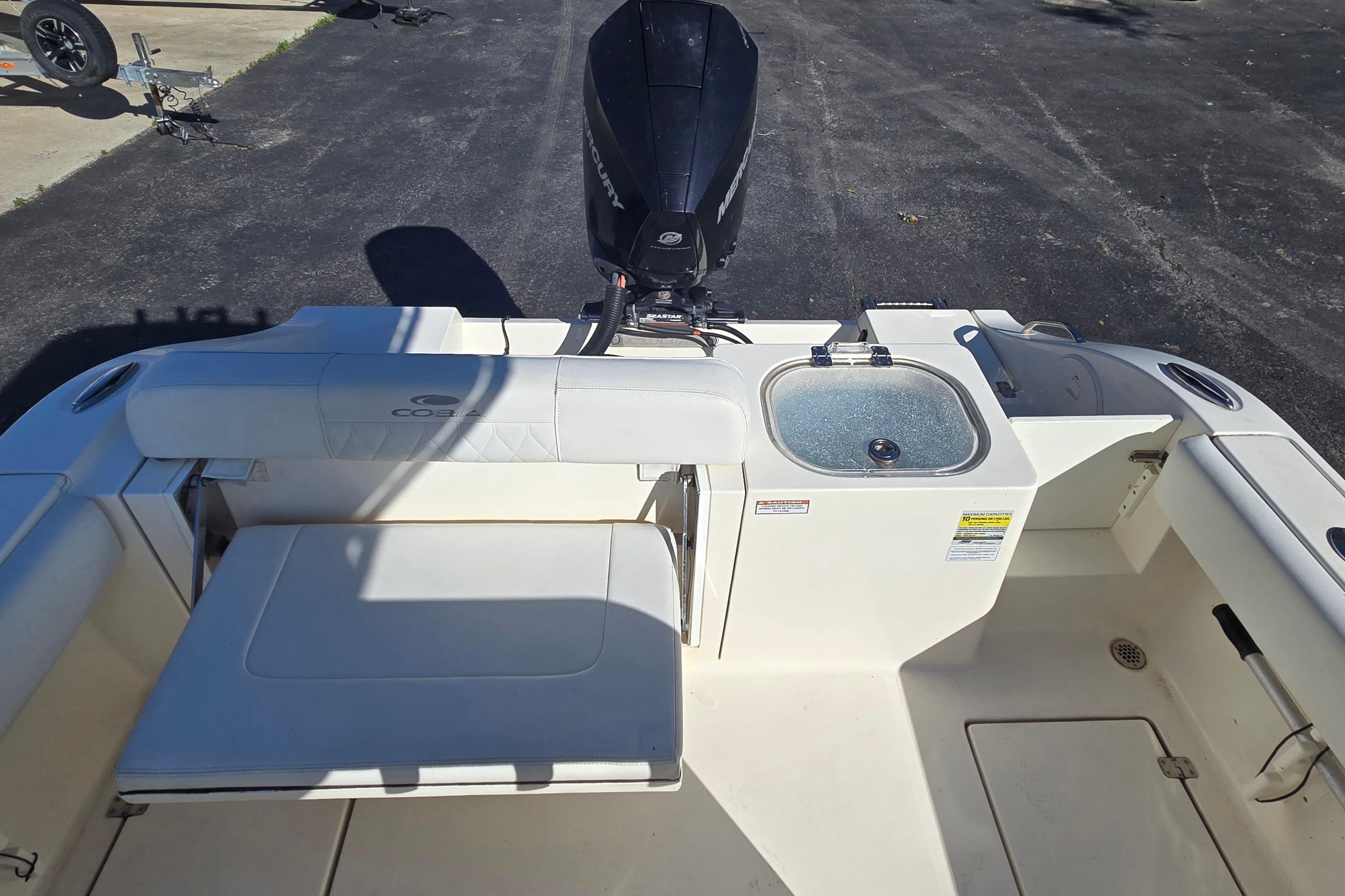 2022 Cobia 237 Center Console boat interior with seating and motor.