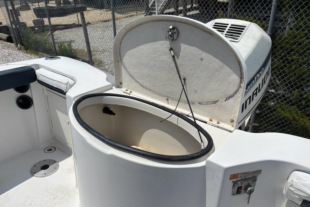 2002 Seaswirl Striper 2101 Center Console O/B boat with open storage compartment.