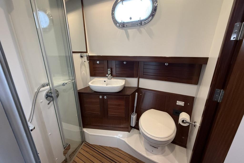 Bathroom interior of 2012 Sasga Yachts Menorquin 42 with shower, sink, and toilet.