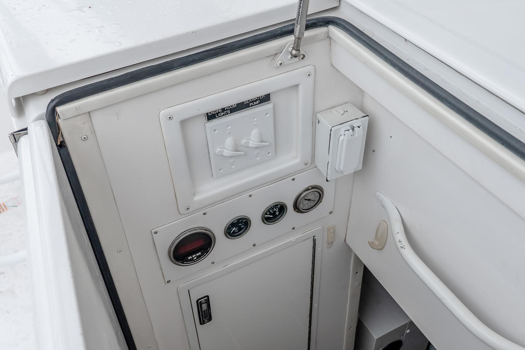 Control panel of a 2000 Viking 50' Convertible yacht, featuring gauges and switches.