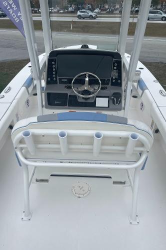 2026 Robalo 246 Cayman boat interior with steering console and rod holders.