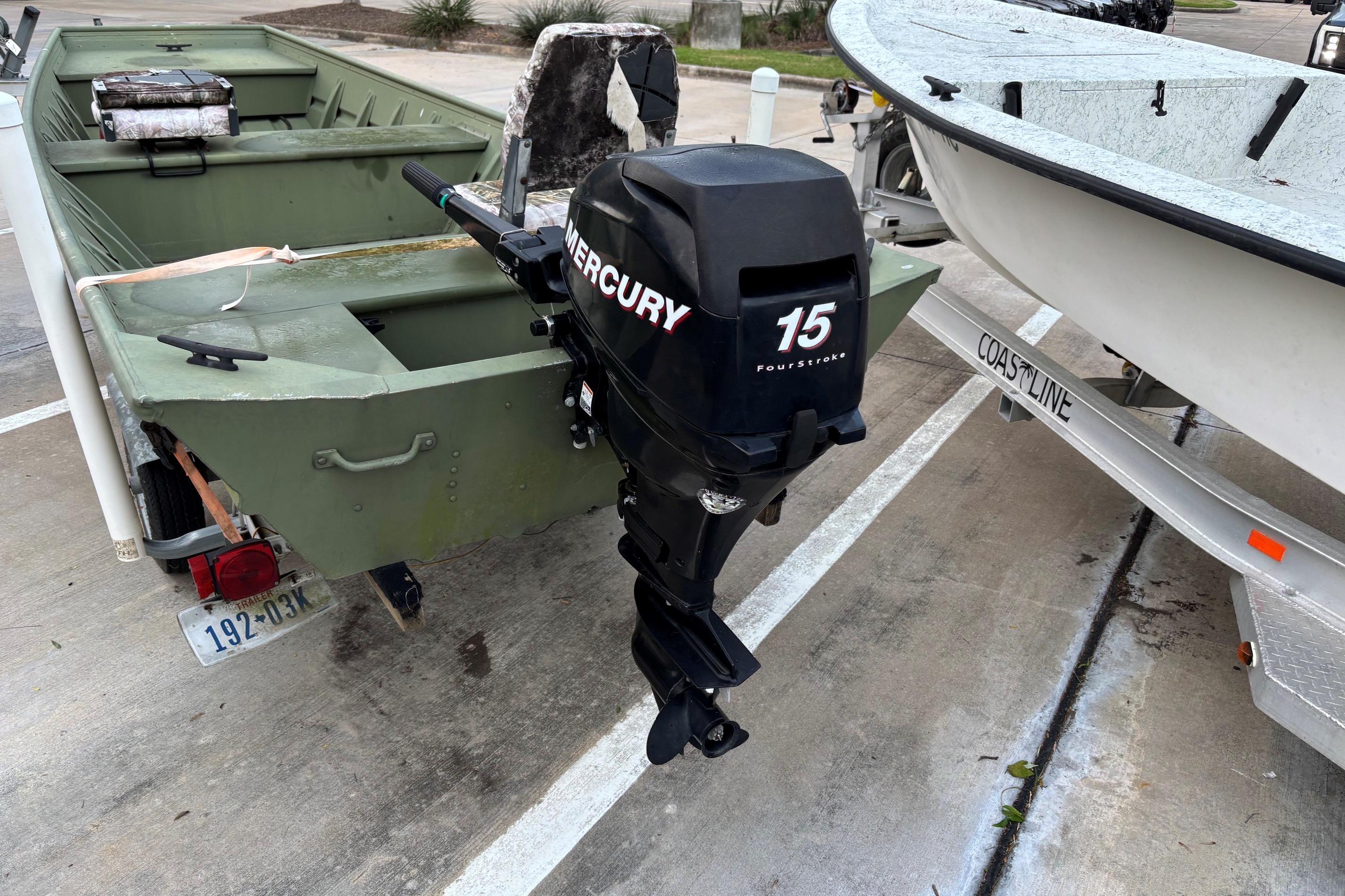 2011 Alumacraft 1542 Jon boat with Mercury 15 horsepower outboard motor in parking lot.