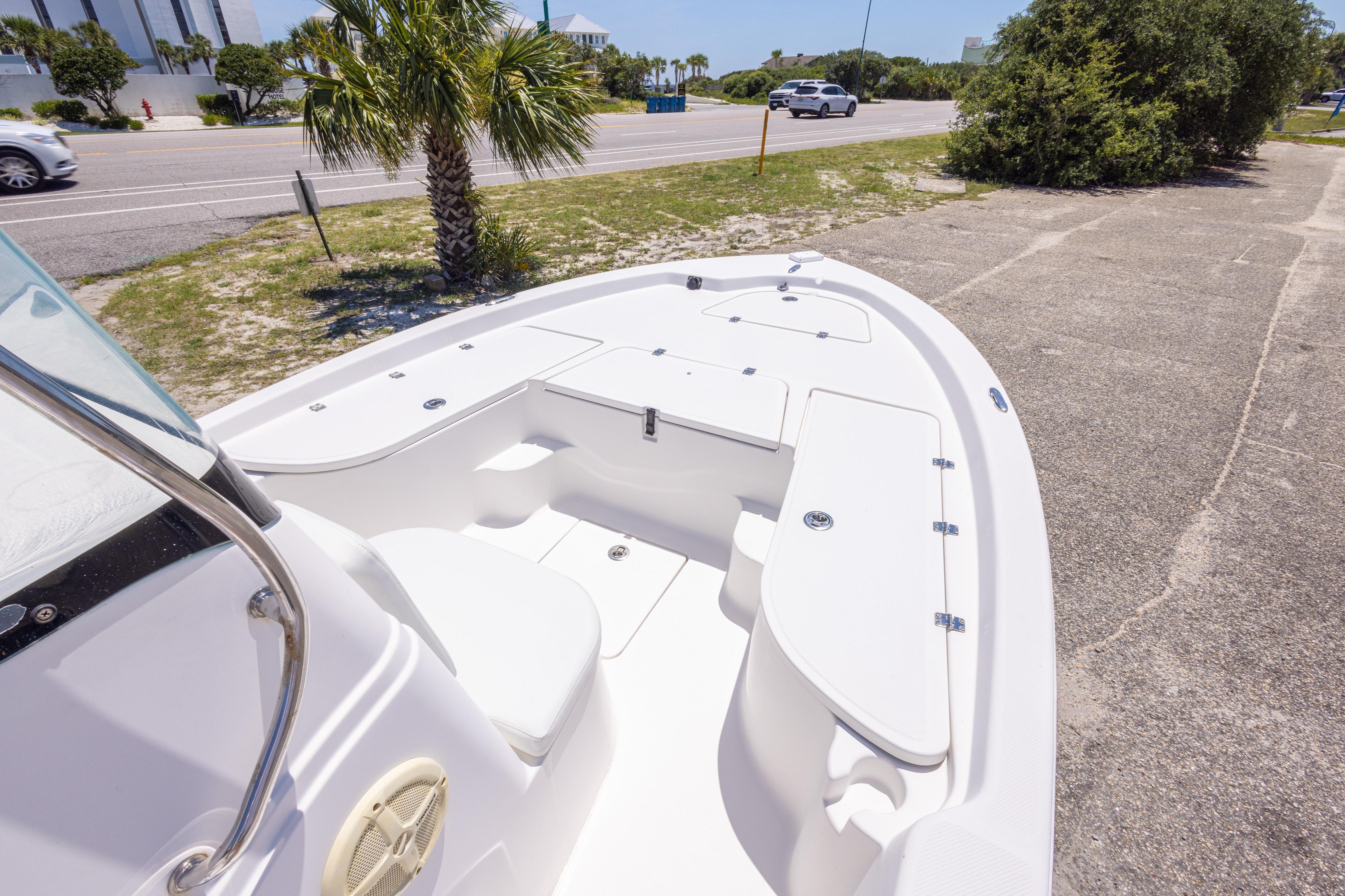 2011 Sea Fox 200XT boat parked near a road with palm trees.