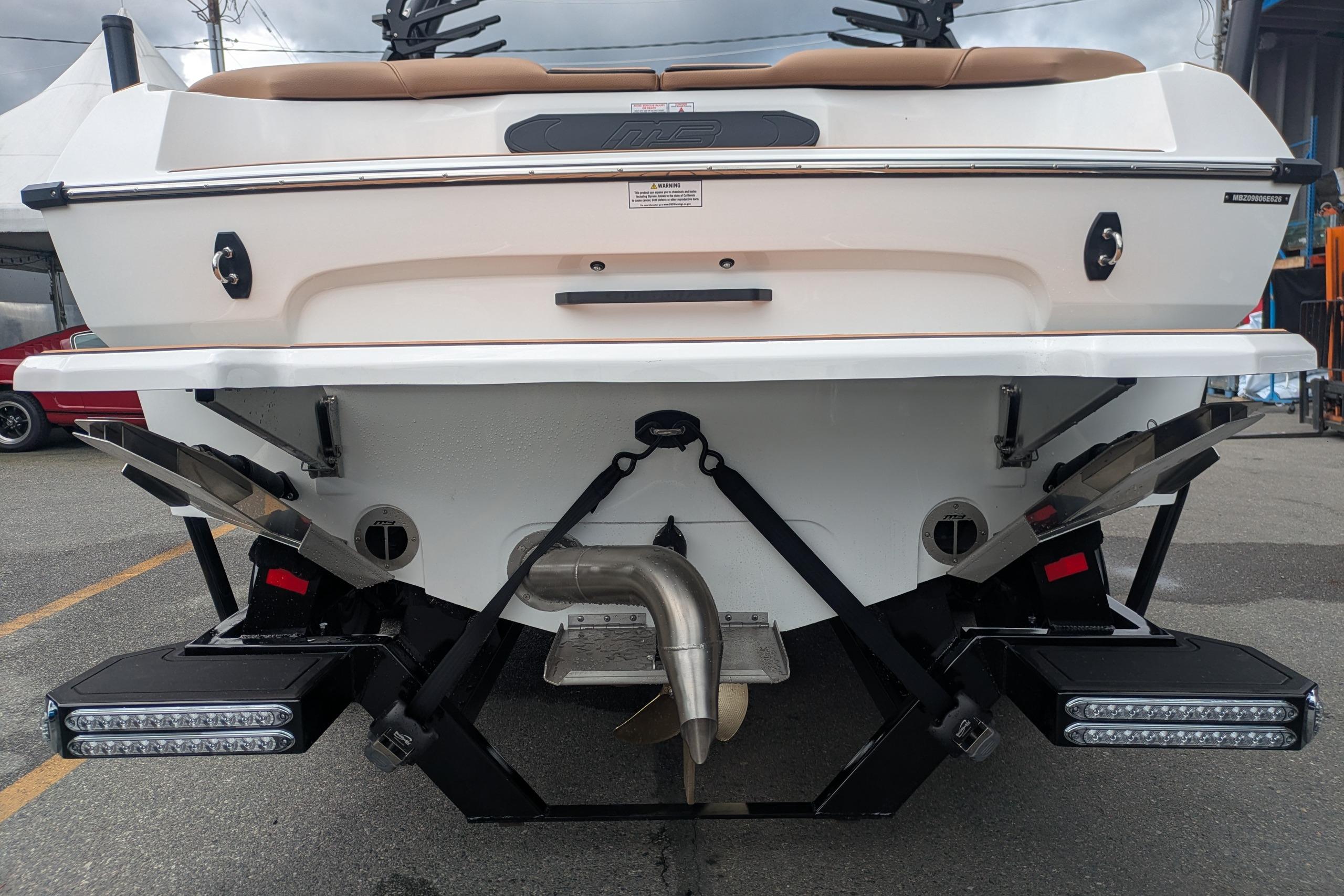 Rear view of 2026 MB B52-23 Classic LIMITED boat with dual exhaust and LED lights.