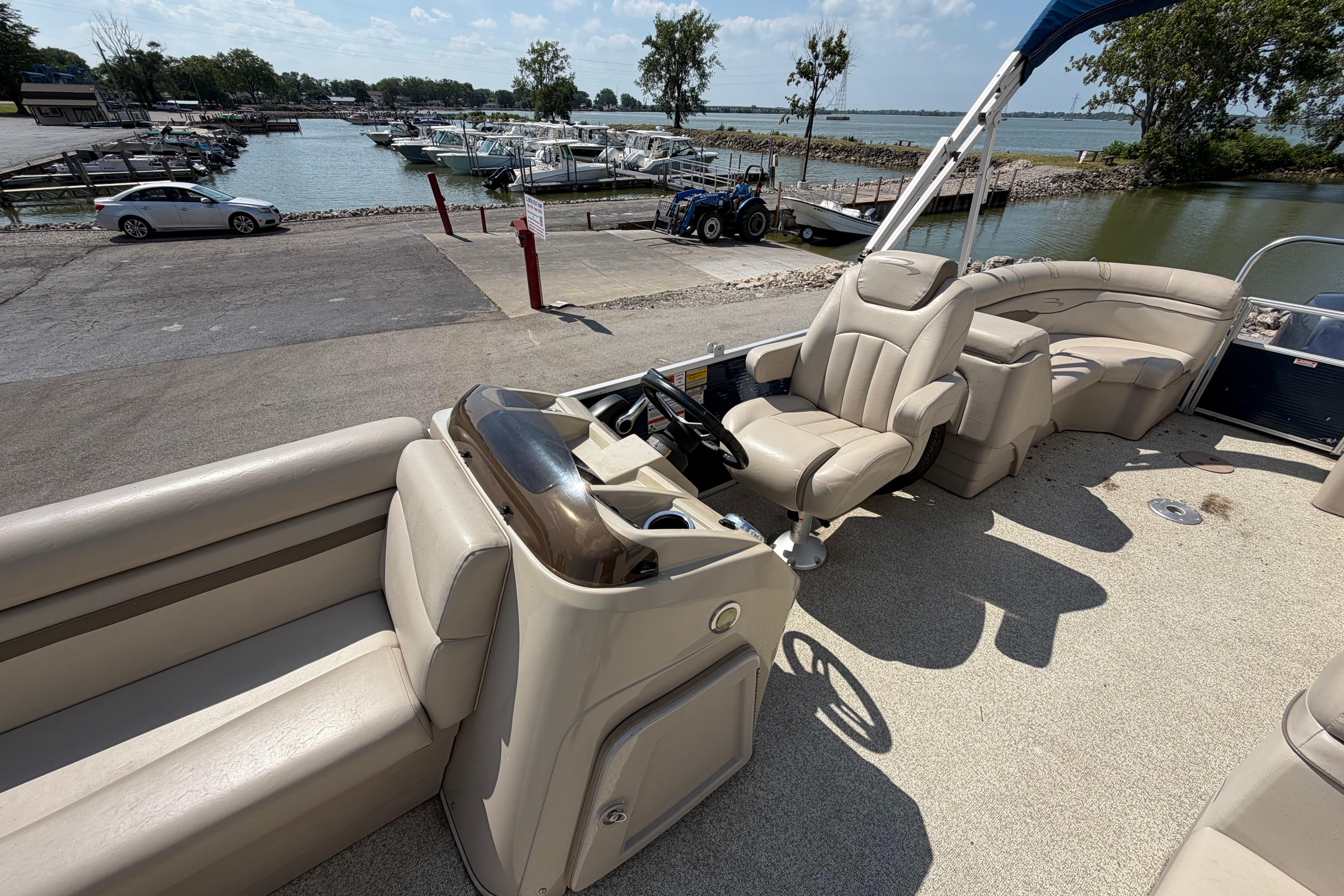 2017 Bennington 25 SSXAPG pontoon boat interior at a marina dock.