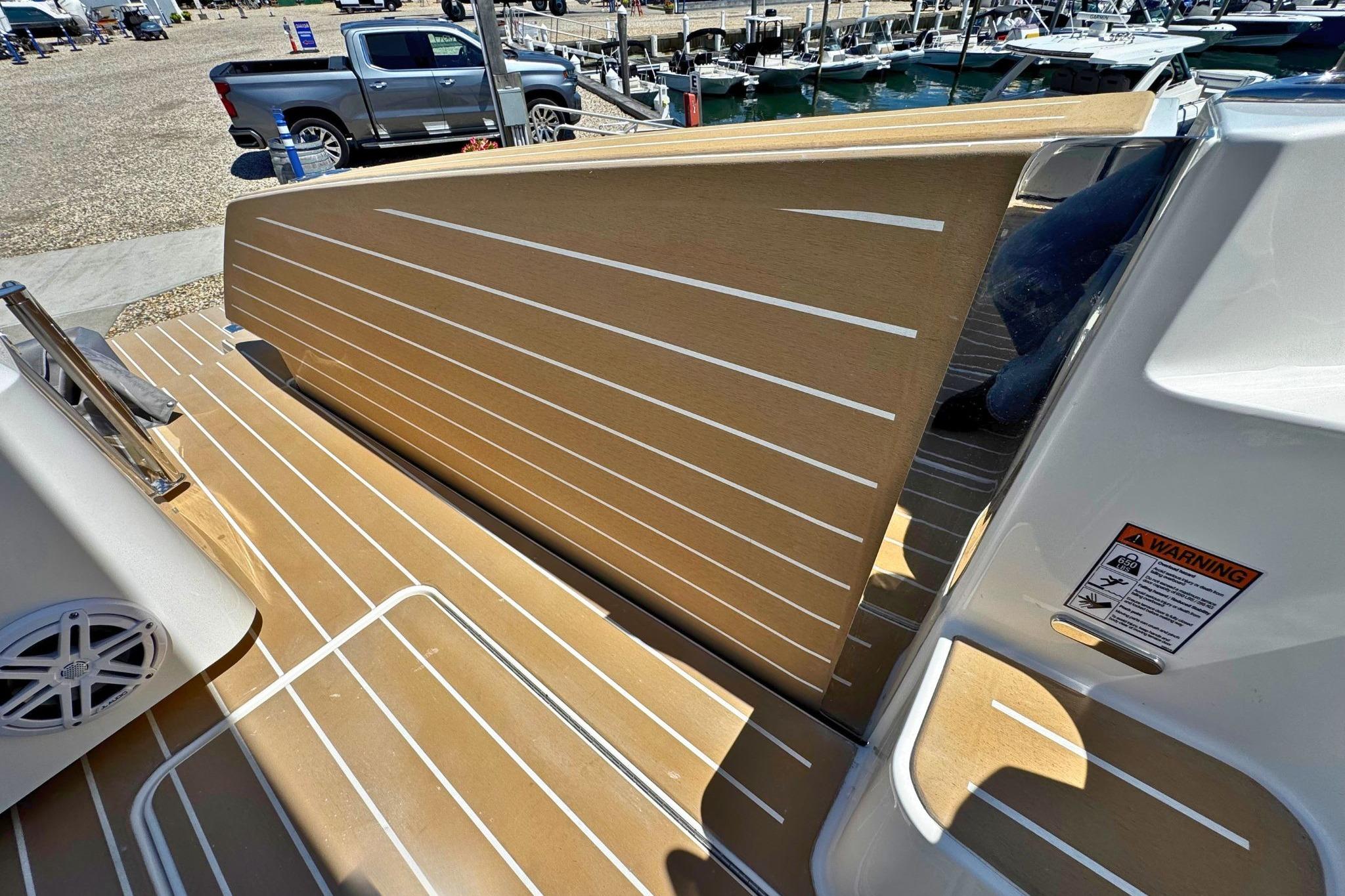 2027 Tiara Yachts 39 LE deck with wood finish and safety warning label.