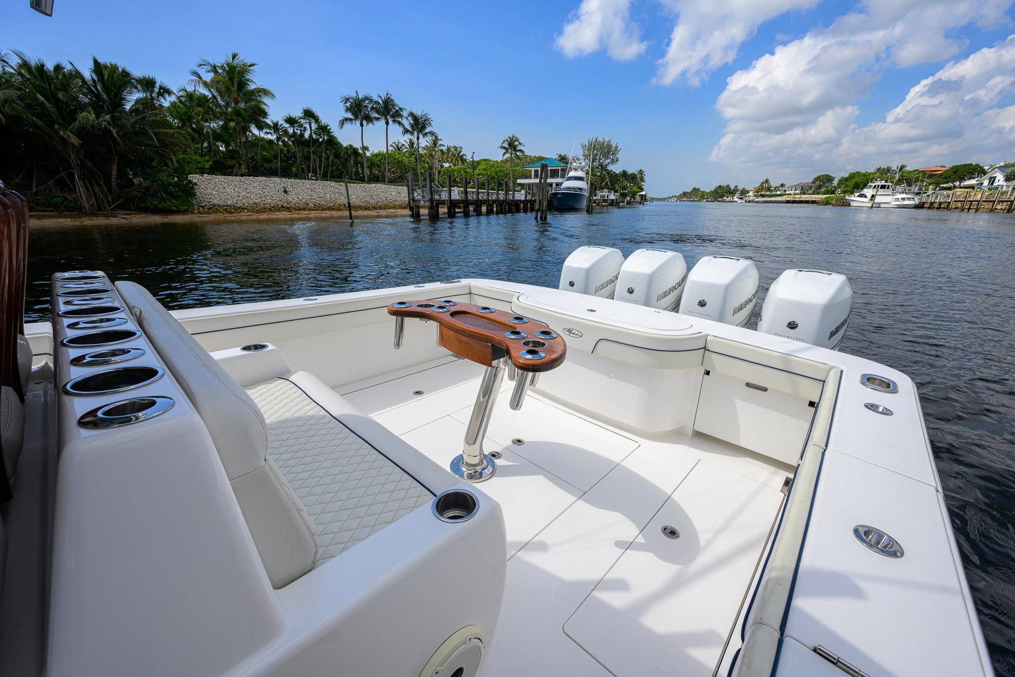 2020 Valhalla Boatworks V-41 with spacious deck and multiple outboard engines on a scenic waterway.