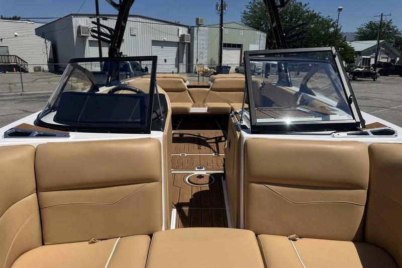 2023 Moomba Mojo Pro boat interior with tan seating and open windshield.