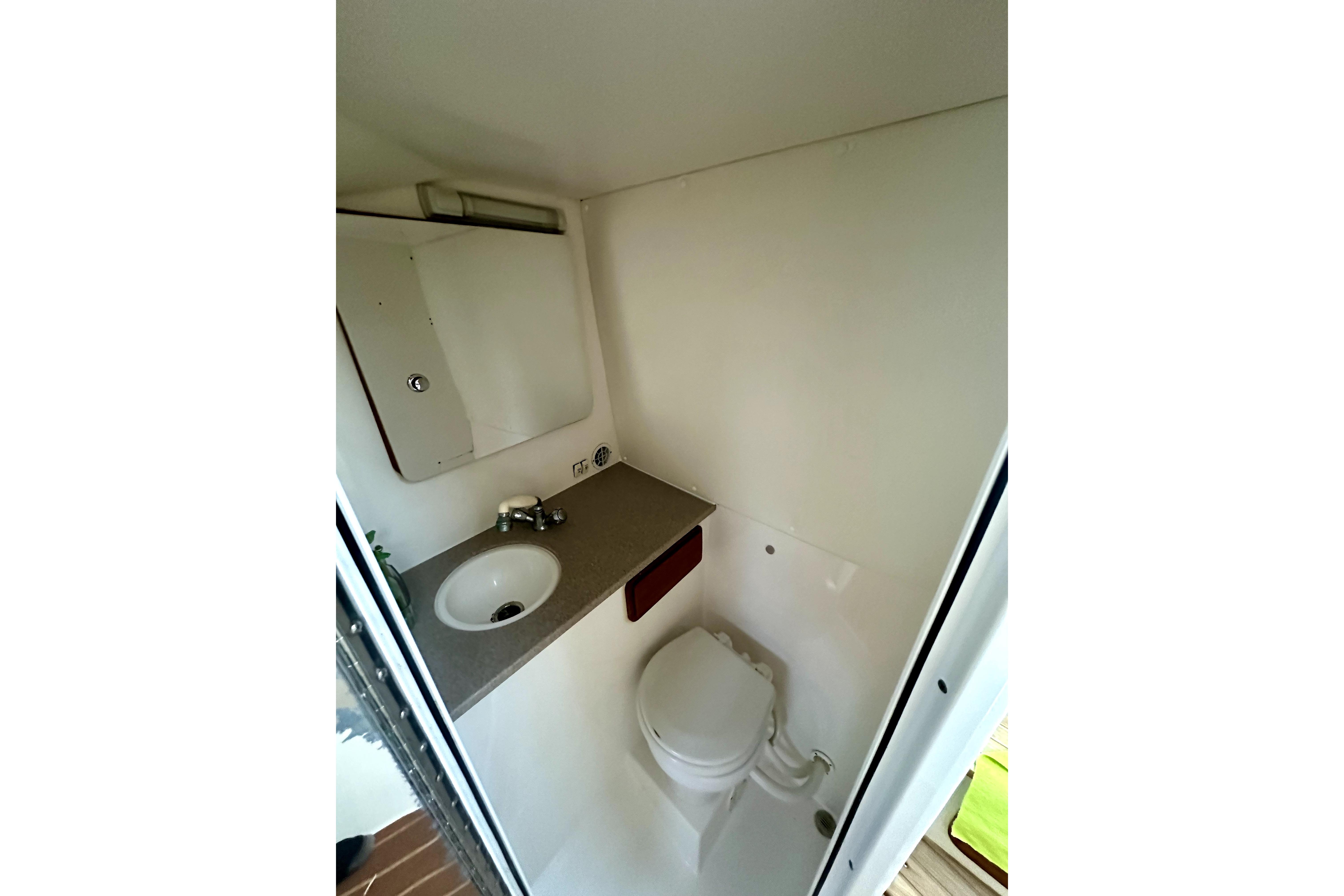 2006 Contender 35 Express Side Console bathroom with sink and toilet.