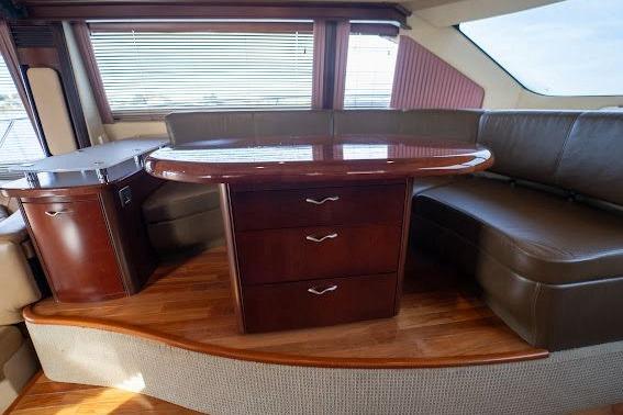 Luxurious interior of 2006 Sea Ray 580 Sedan Bridge with elegant wood and leather seating.