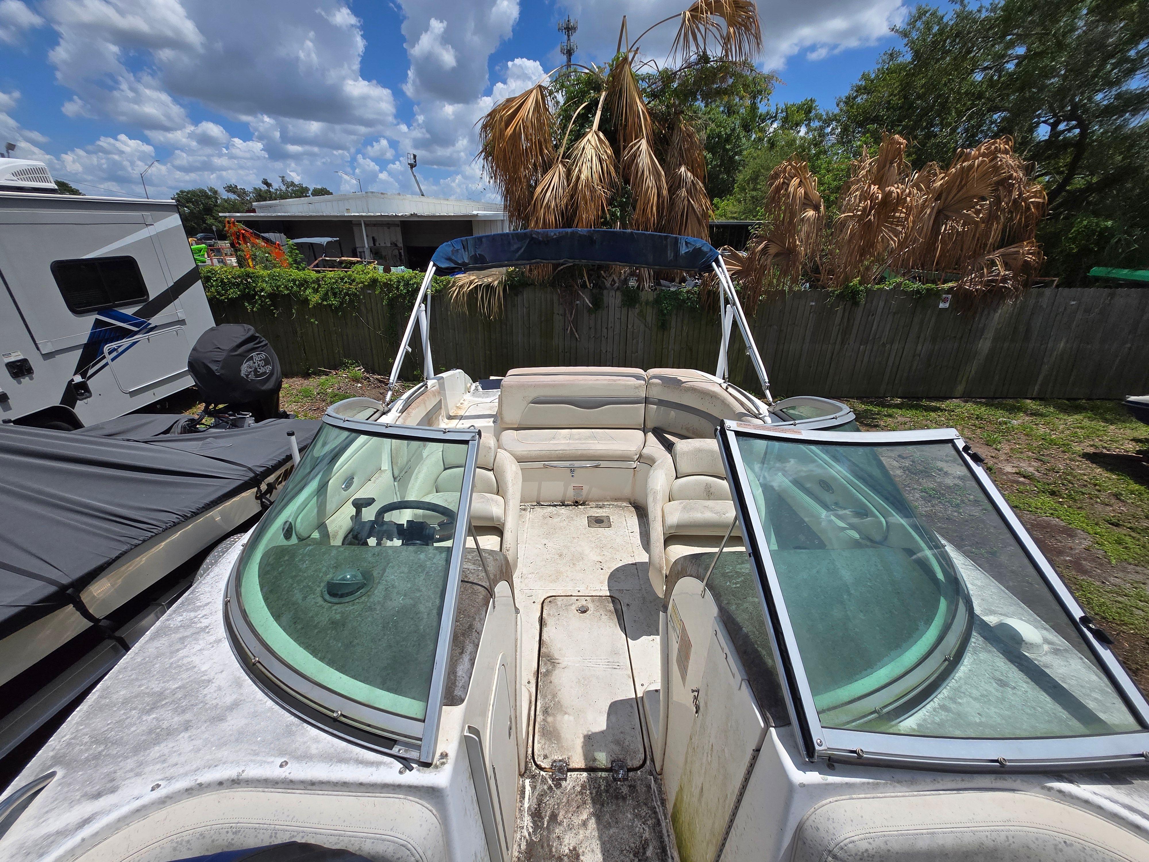 A 2006 Chaparral 220 SSi boat is on dry land. It features an open cockpit.