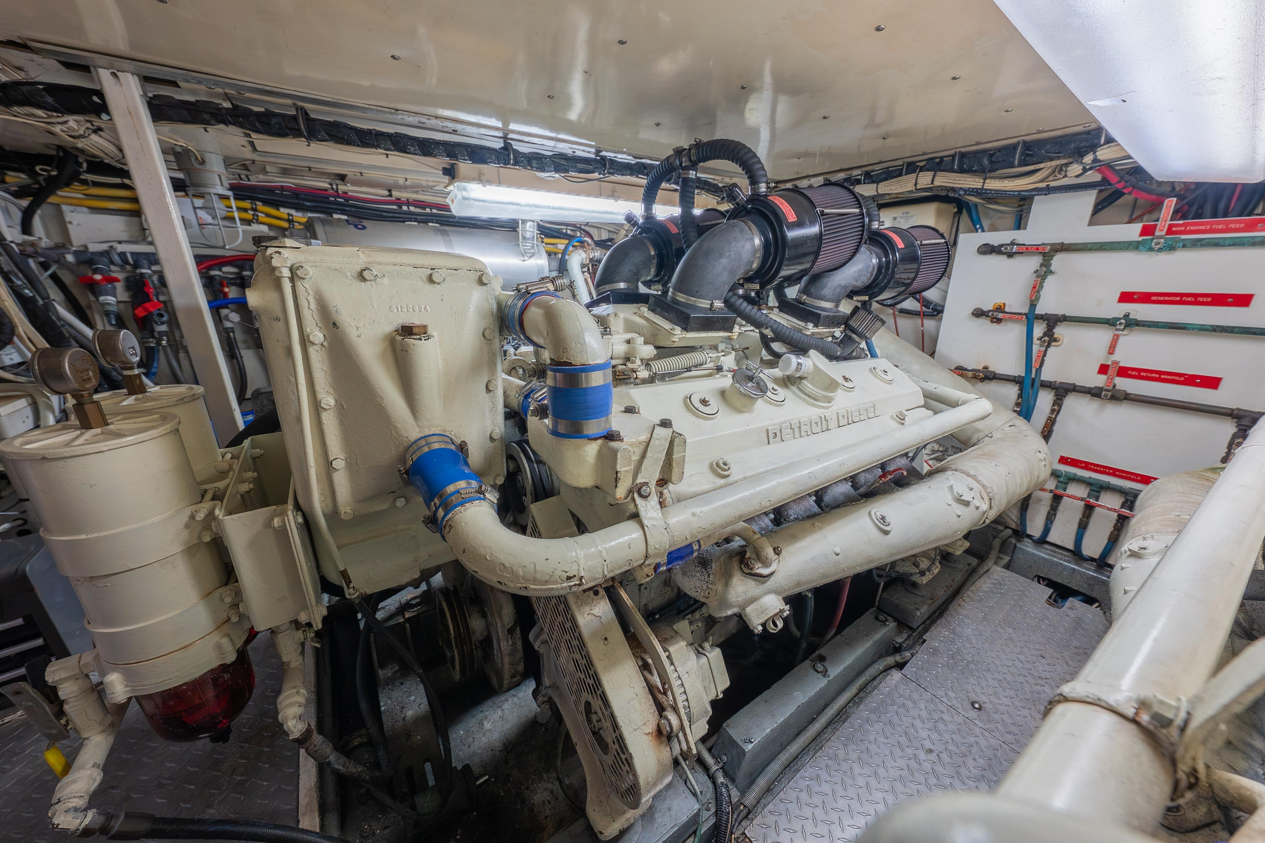 Engine room of a 1963 Trumpy Classic yacht, showcasing a vintage diesel engine.