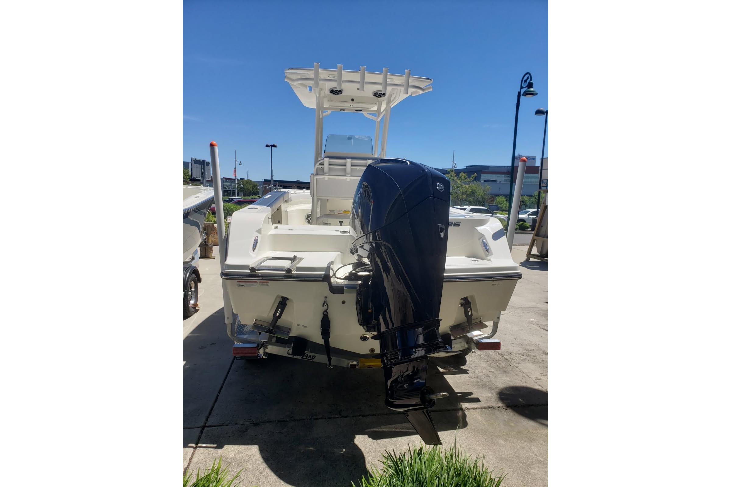2026 Mako 226 Center Console boat with powerful outboard motor, parked outdoors.