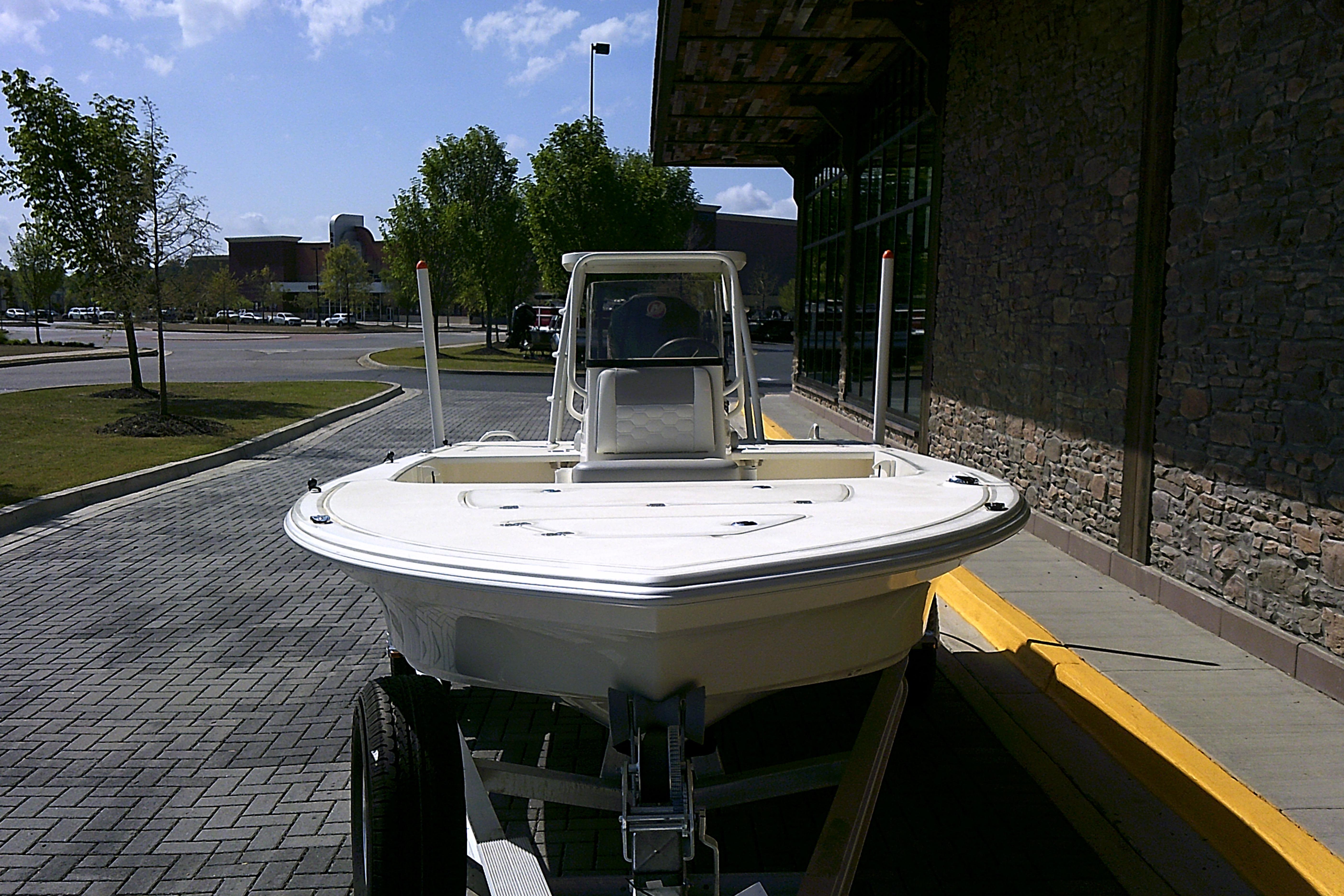 2026 Mako 18 Pro Skiff boat on trailer in parking lot.