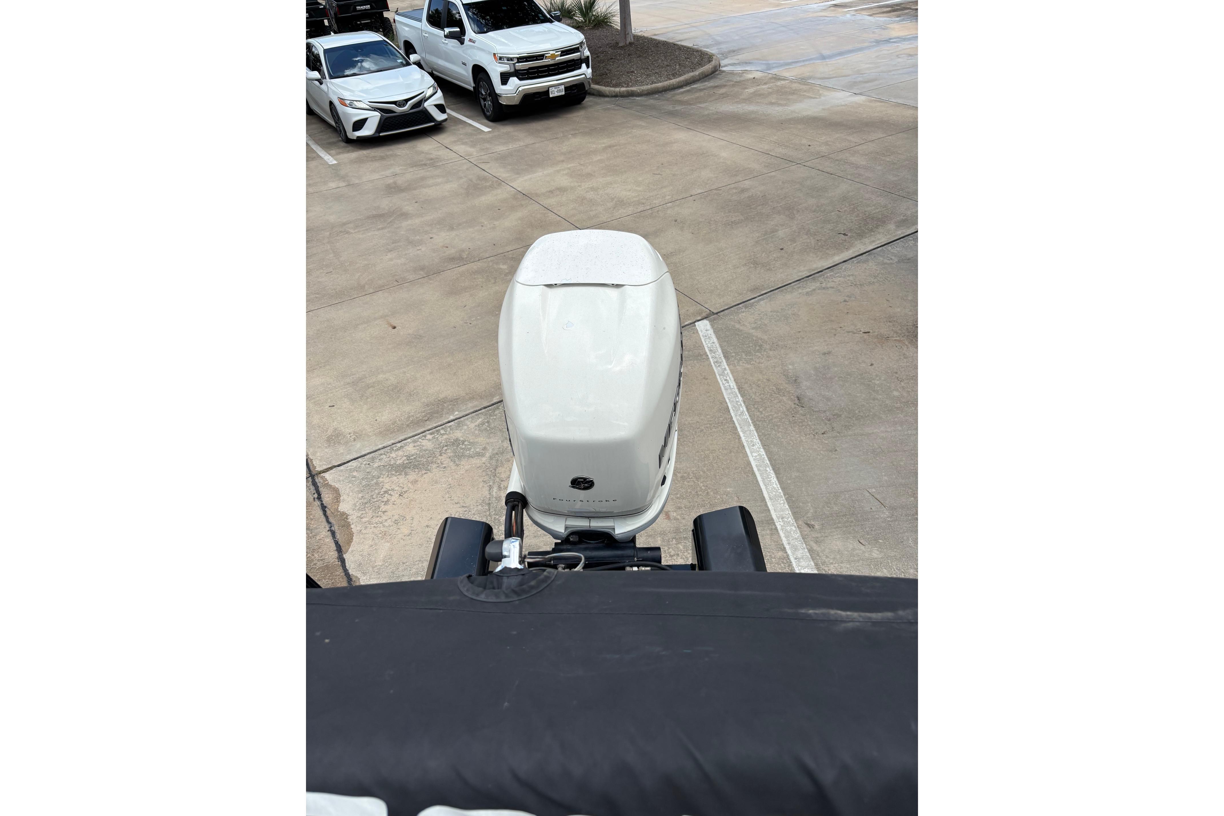 Top view of a 2018 Regency 254 LE3 Sport boat engine in a parking lot.