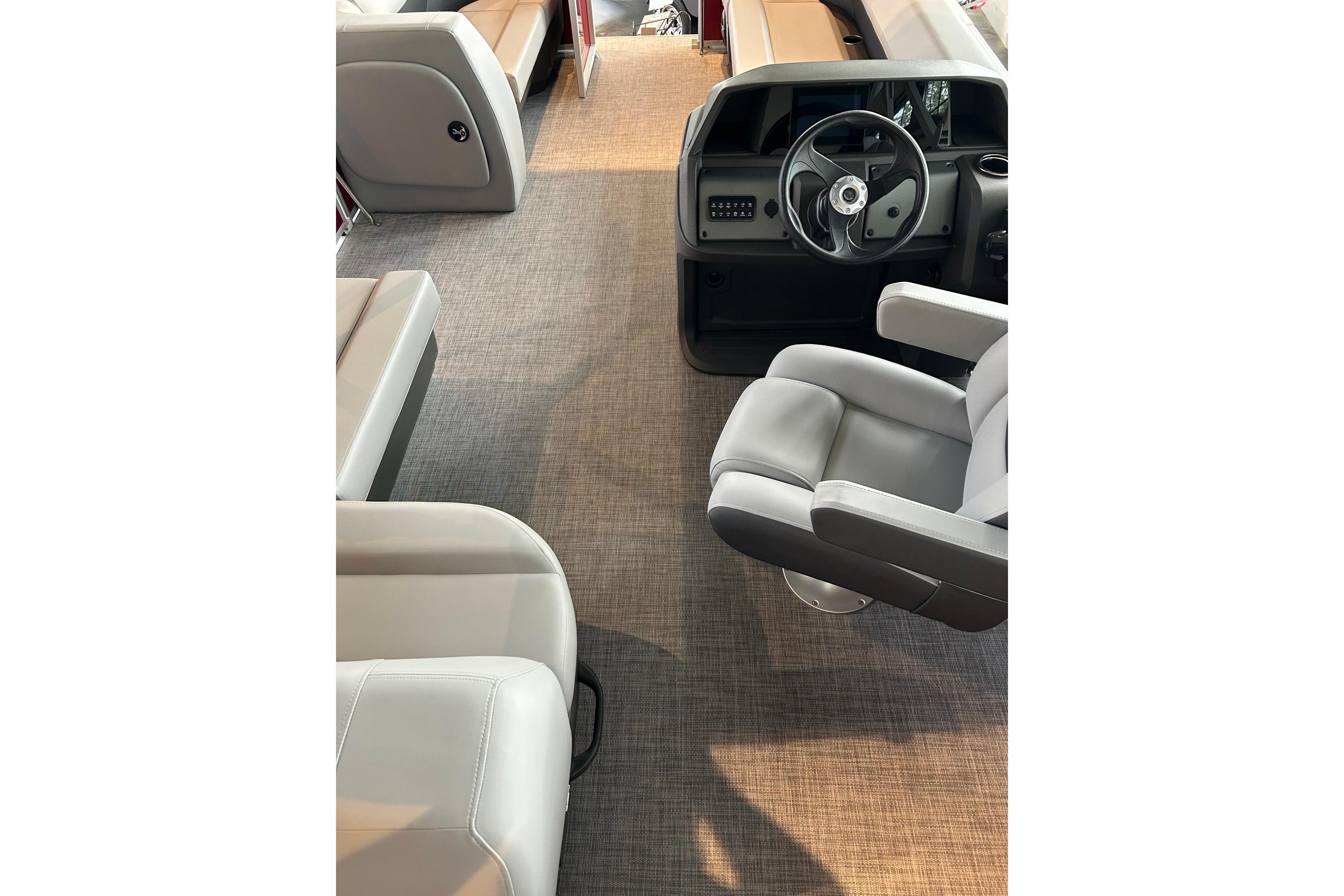 Interior of 2026 Sun Tracker Party Barge 18 DLX with seating and steering console.
