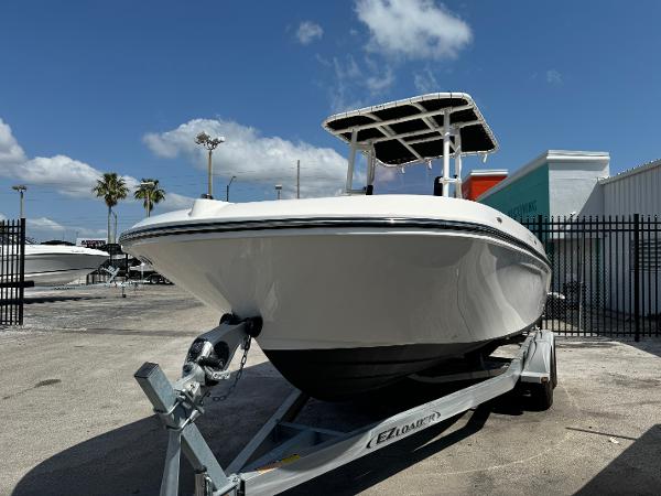 2021 Bayliner Trophy T22CC boat on trailer under clear blue sky.