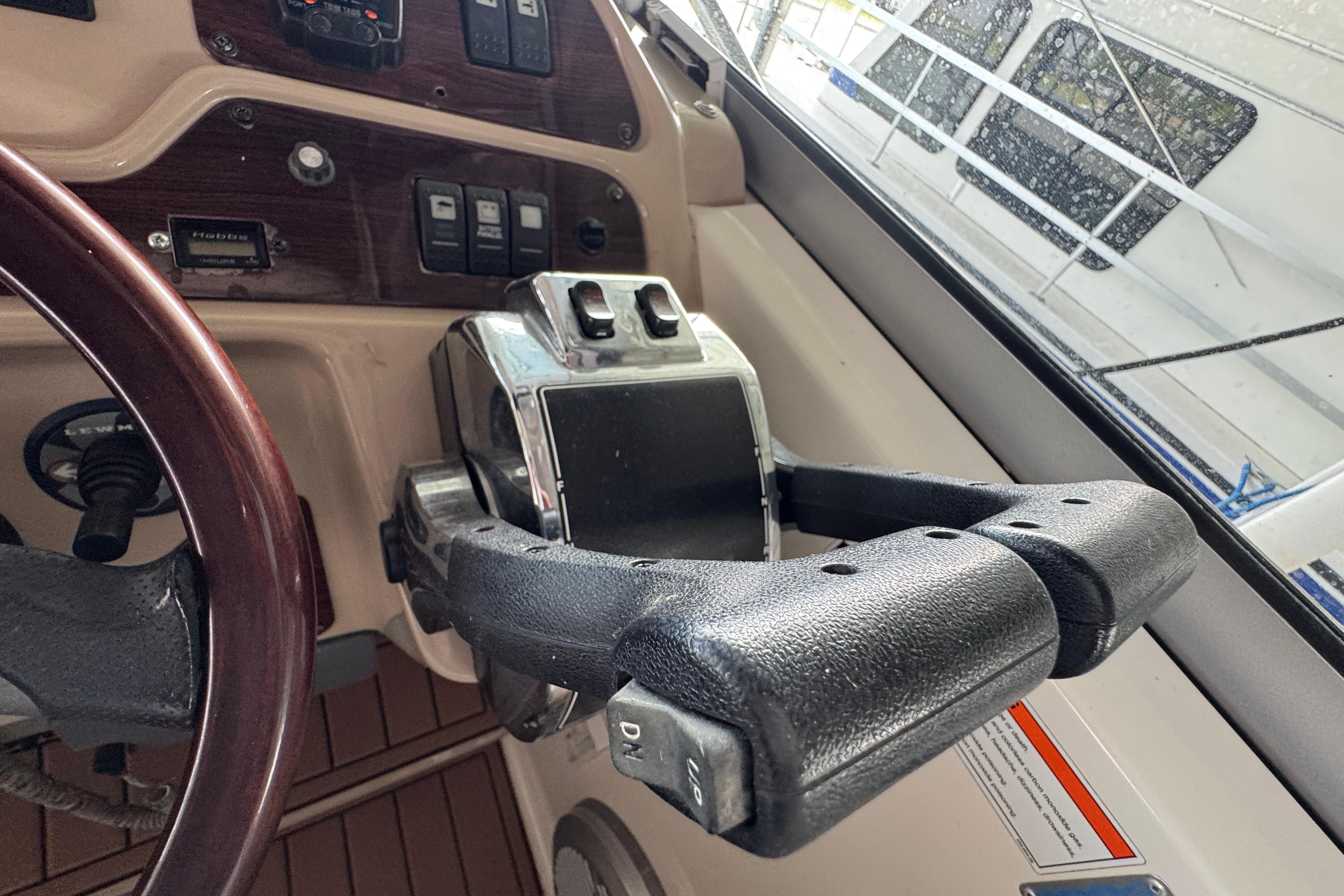2006 Chaparral 330 Signature boat helm with controls and steering wheel.